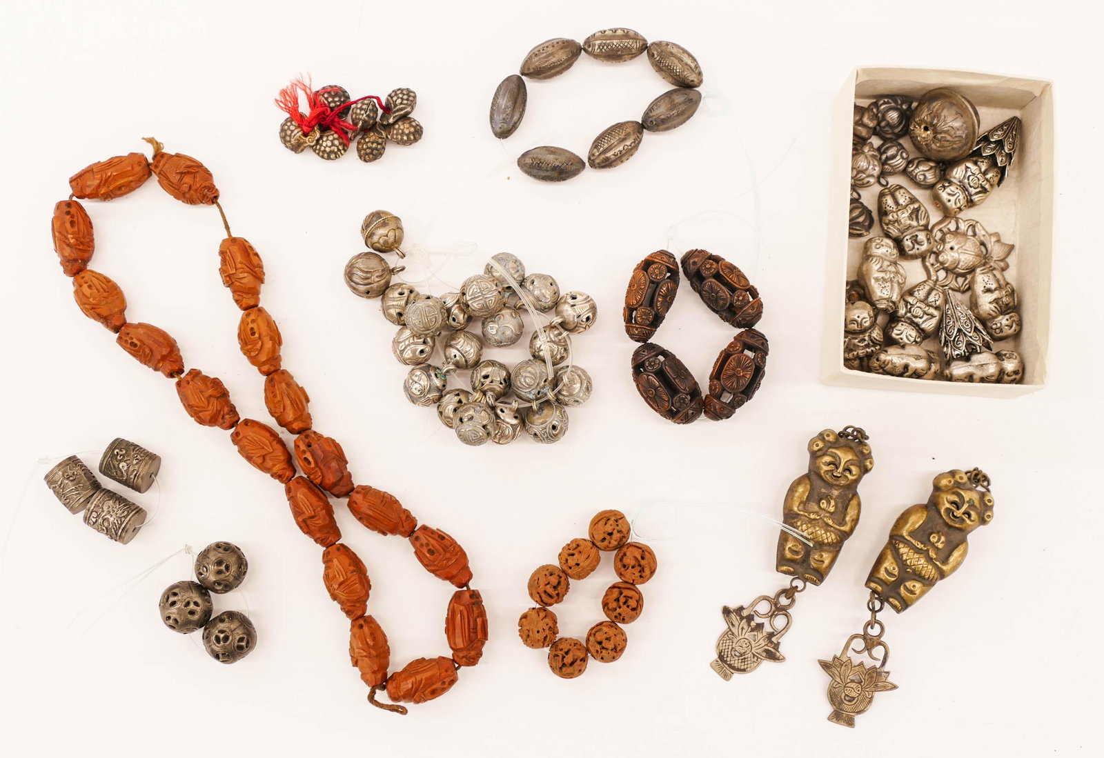 Collection of Chinese Prayer Beads & Toggles .5'' to: Collection of Chinese Prayer Beads & Toggles .5'' to 3.5'' Long. Includes fine buddhist pierced carved walnut beads, pierced silver robe beads, a pair of children toggles, etc. Some wear from age. 19t