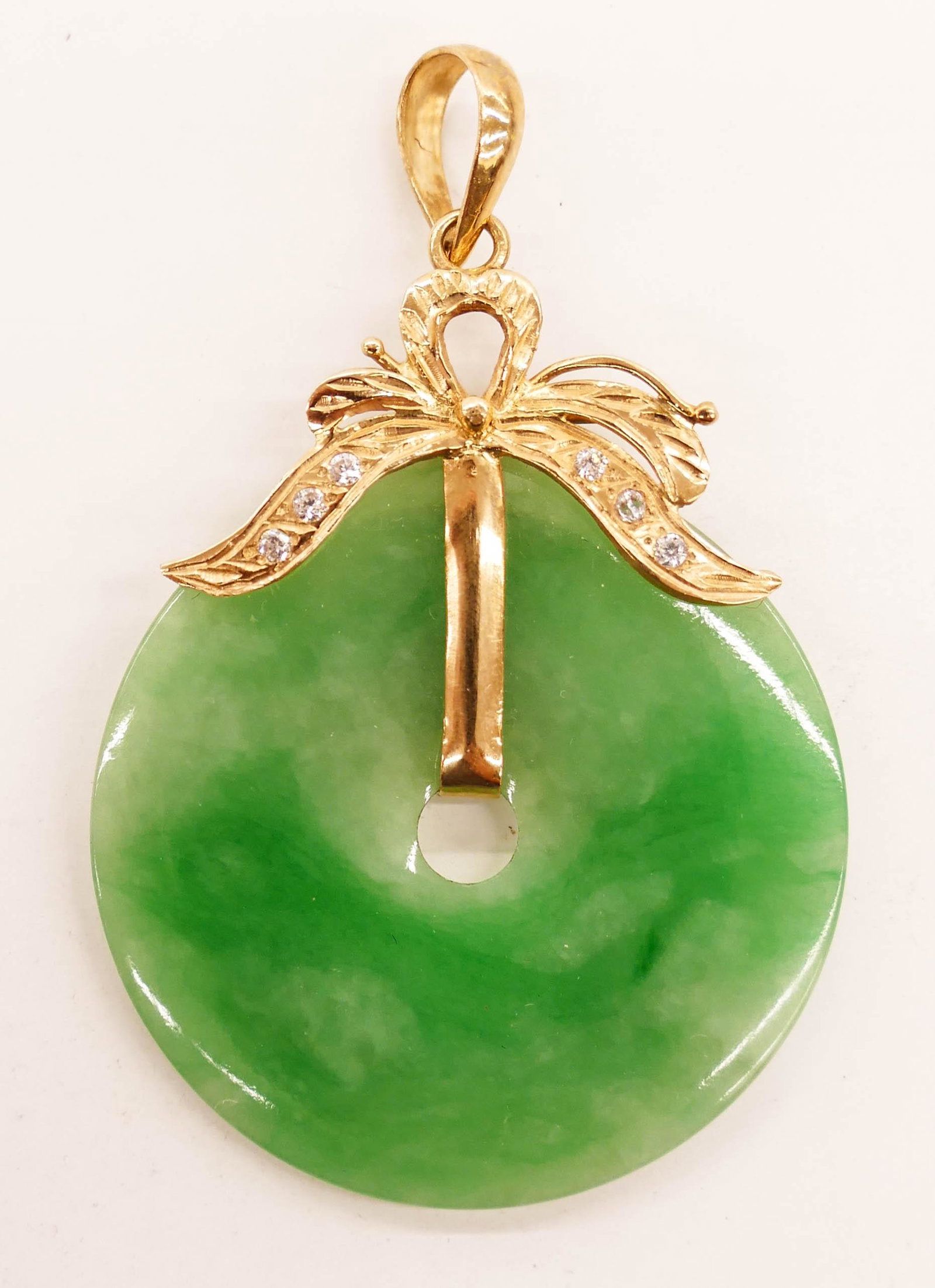 Chinese Jadeite & Diamond 18k Bi Disc Pendant: Chinese Jadeite & Diamond 18k Bi Disc Pendant 2''x1.5''. An apple green to white jade disc pendant mounted in 18k gold with six round cut small diamonds. Hoop is marked 18K 750. It weighs 10 grams tot