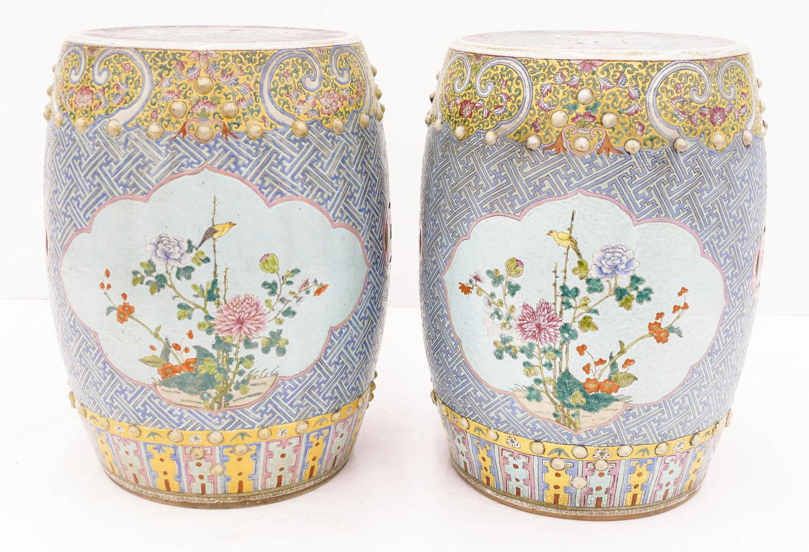 Pair of Chinese Qing Garden Seats Famille Rose: Pair of Chinese Qing Garden Seats Famille Rose Porcelain 19''x14'' Each. A true pair opposing pair of polychrome enameled drum form seats. Pierced double coin and medallion motifs with blossoming flow