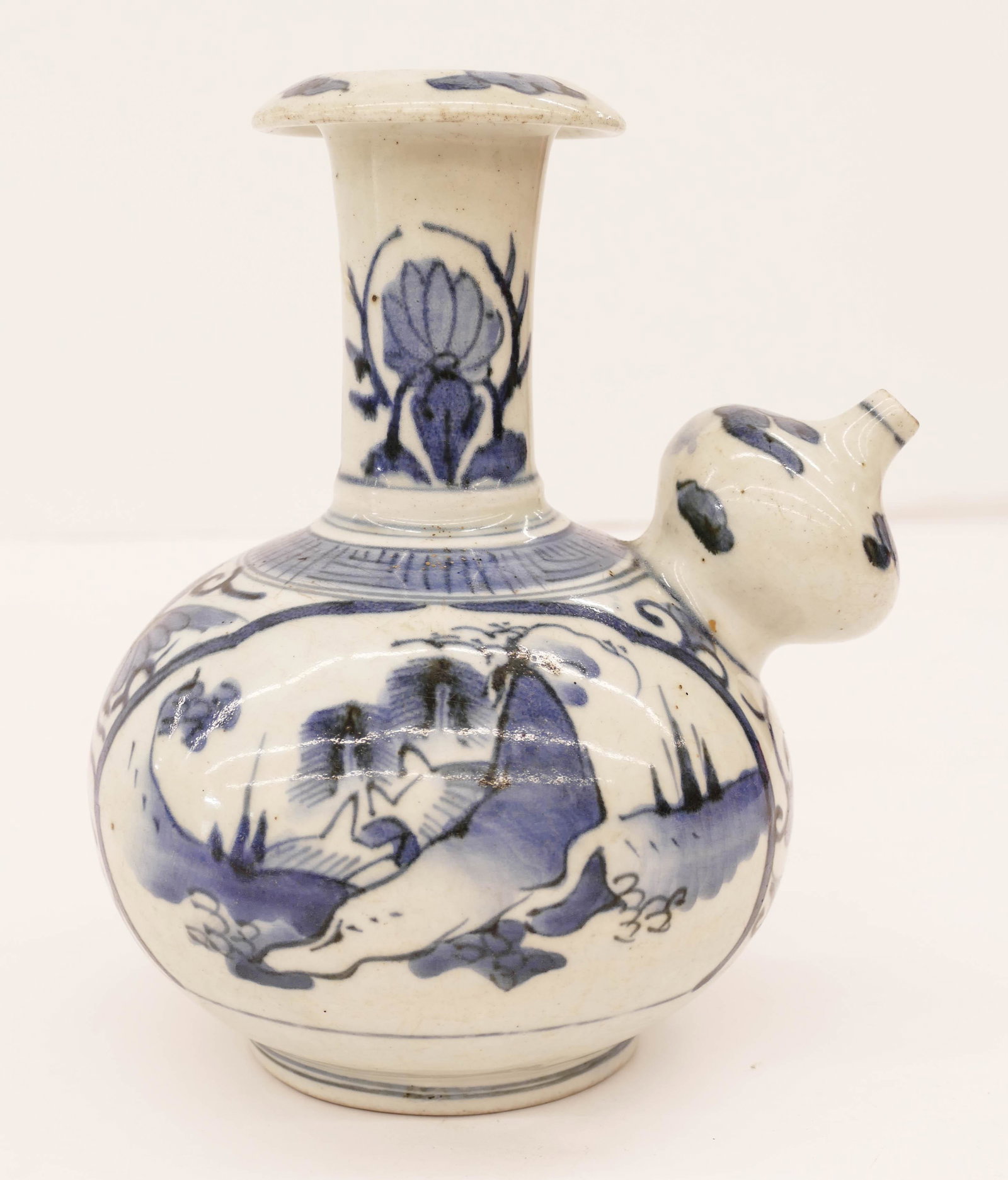 Chinese Wanli Porcelain Kraak Kendi Ewer 8''x6.5''.: Chinese Wanli Porcelain Kraak Kendi Ewer 8''x6.5''. Blue and white underglaze landscape decoration. Slight flake to top edge and a .5'' hairline on spout. 16th century, Ming dynasty. Vietnamese, Annam