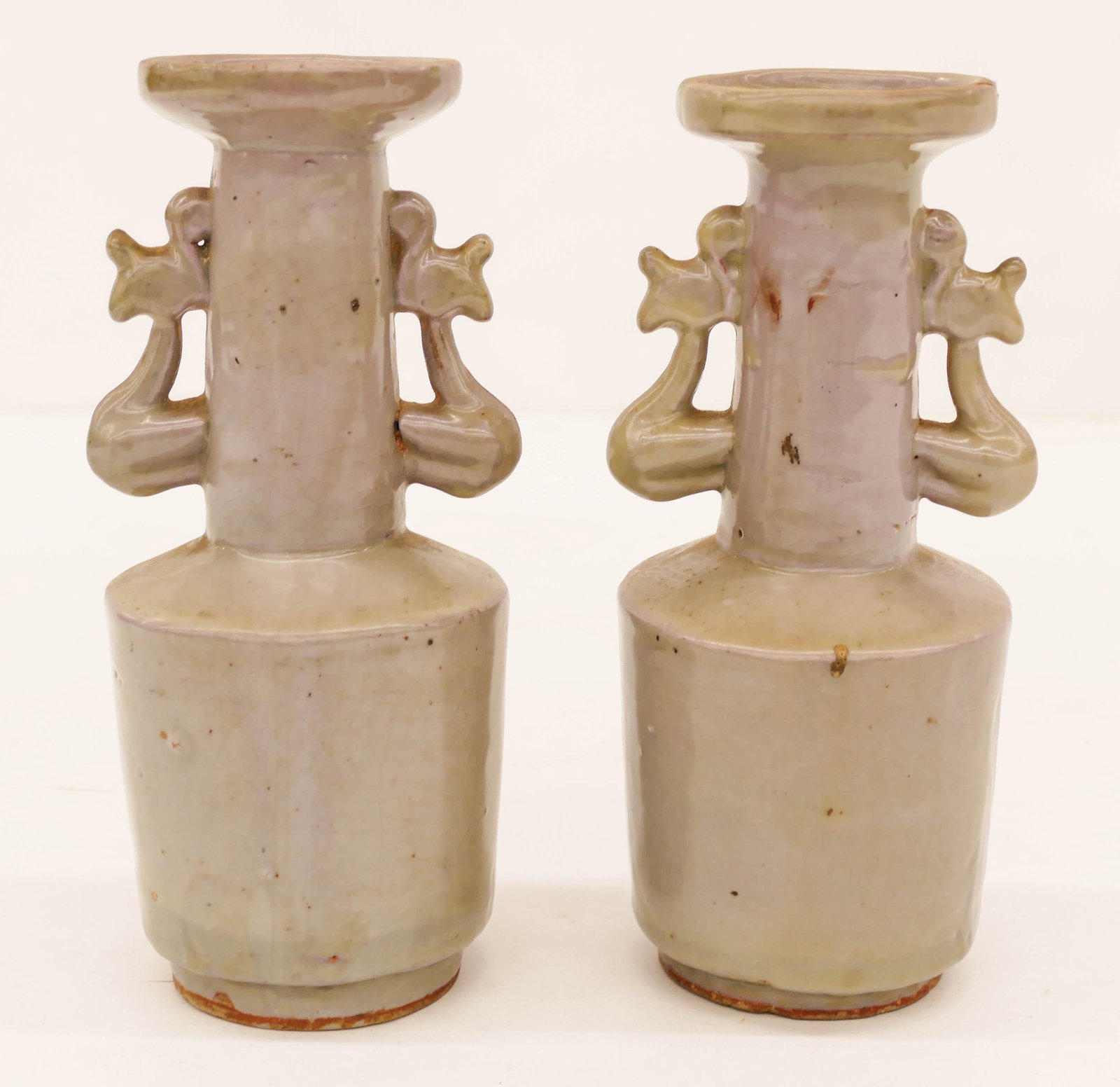 Pair of Old Chinese Longquan Ceramic Mallet Vases: Pair of Old Chinese Longquan Ceramic Mallet Vases 7''x3'' Approx. Light celadon glazed thick handled vases. Some scattered glaze imperfections, original to their manufacture. Excellent condition with 