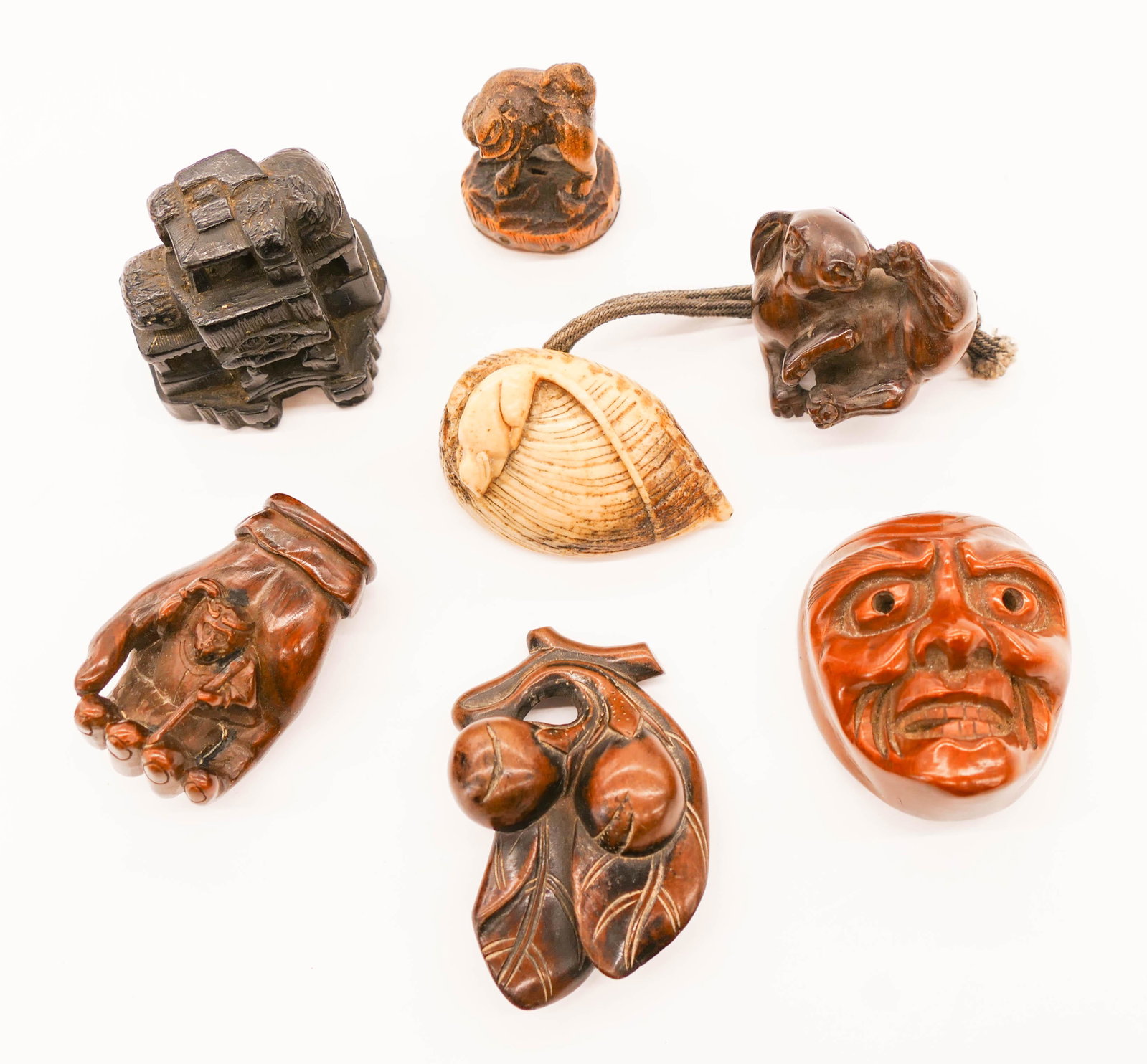 7pc Old Japanese Netsuke Boxwood and Bone 1.25'' to 2'': 7pc Old Japanese Netsuke Boxwood and Bone 1.25'' to 2'' Long. Includes a noh mask, temple, hand with monkey, rabbit, peach branch, foo dog, and rat on shell. Two are signed. Some wear from use. 18th t
