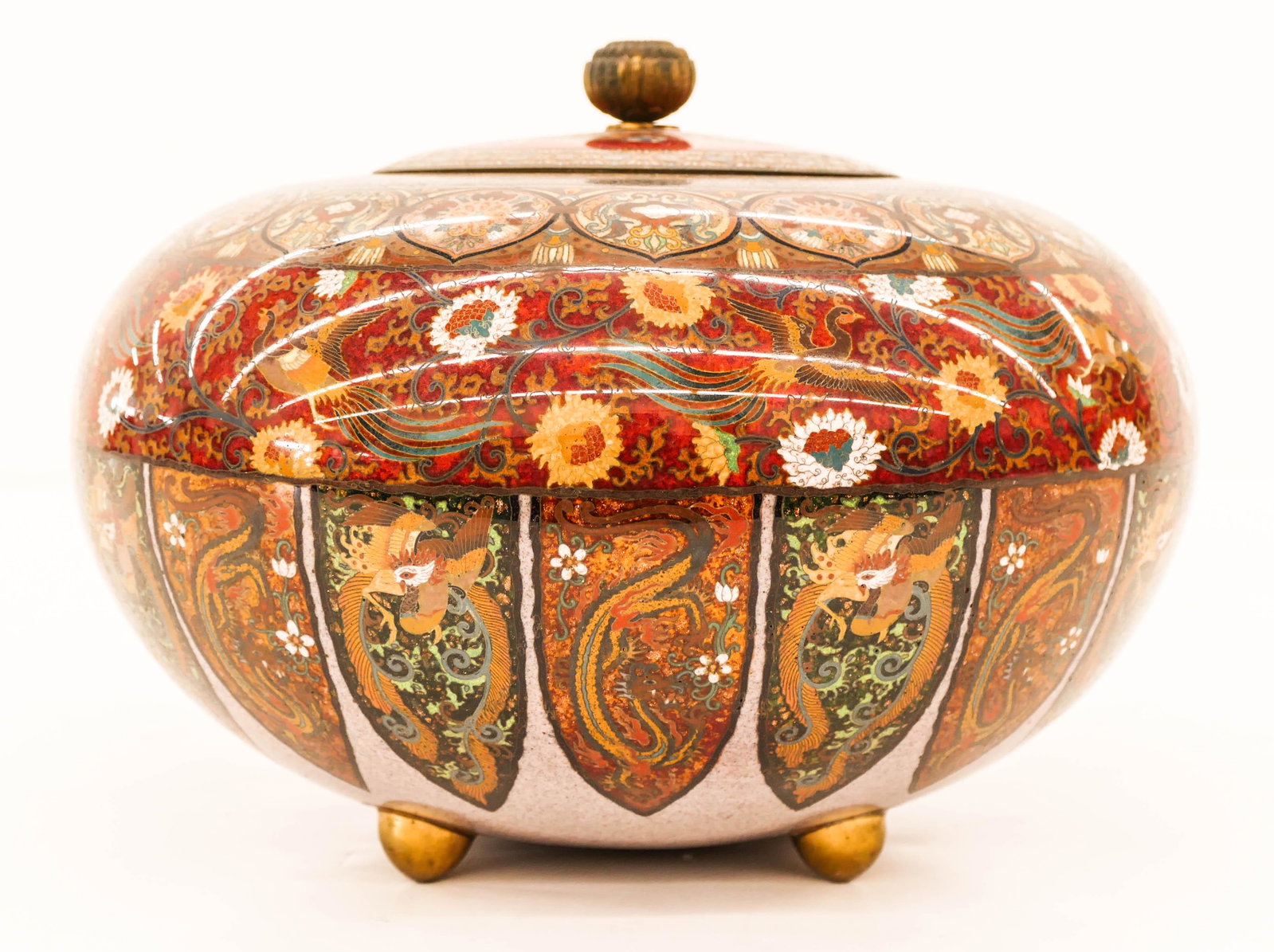 Fine Japanese Cloisonne Dragon Covered Jar 7''x9.5''. A: Fine Japanese Cloisonne Dragon Covered Jar 7''x9.5''. A wide tripod footed jar with intricate polychrome dragon and phoenix motif. Excellent condition. Late 19th or early 20th century, Meiji period. S