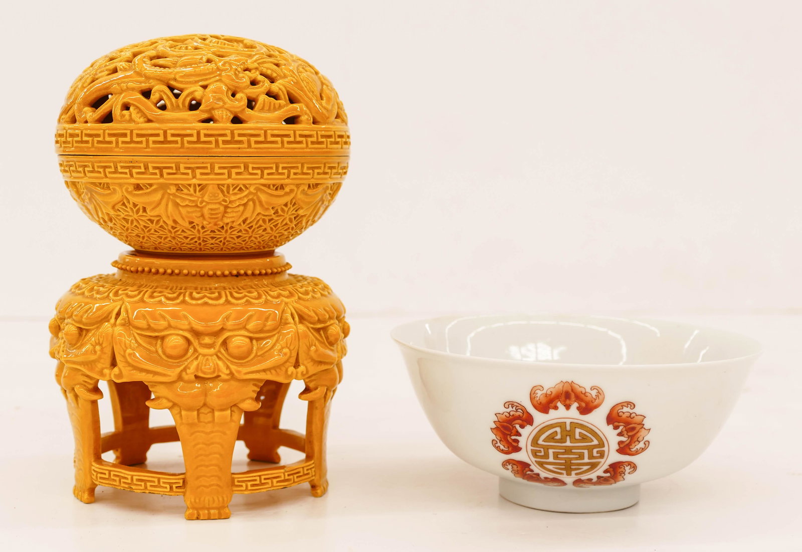 2pc Chinese Commemorative Porcelain. Includes a gilt: 2pc Chinese Commemorative Porcelain. Includes a gilt red enameled bat and shou bowl with Daoguang mark 2.5''x6'' and a yellow monochrome pierced dragon shou box on stand with impressed Qianlong mark 7