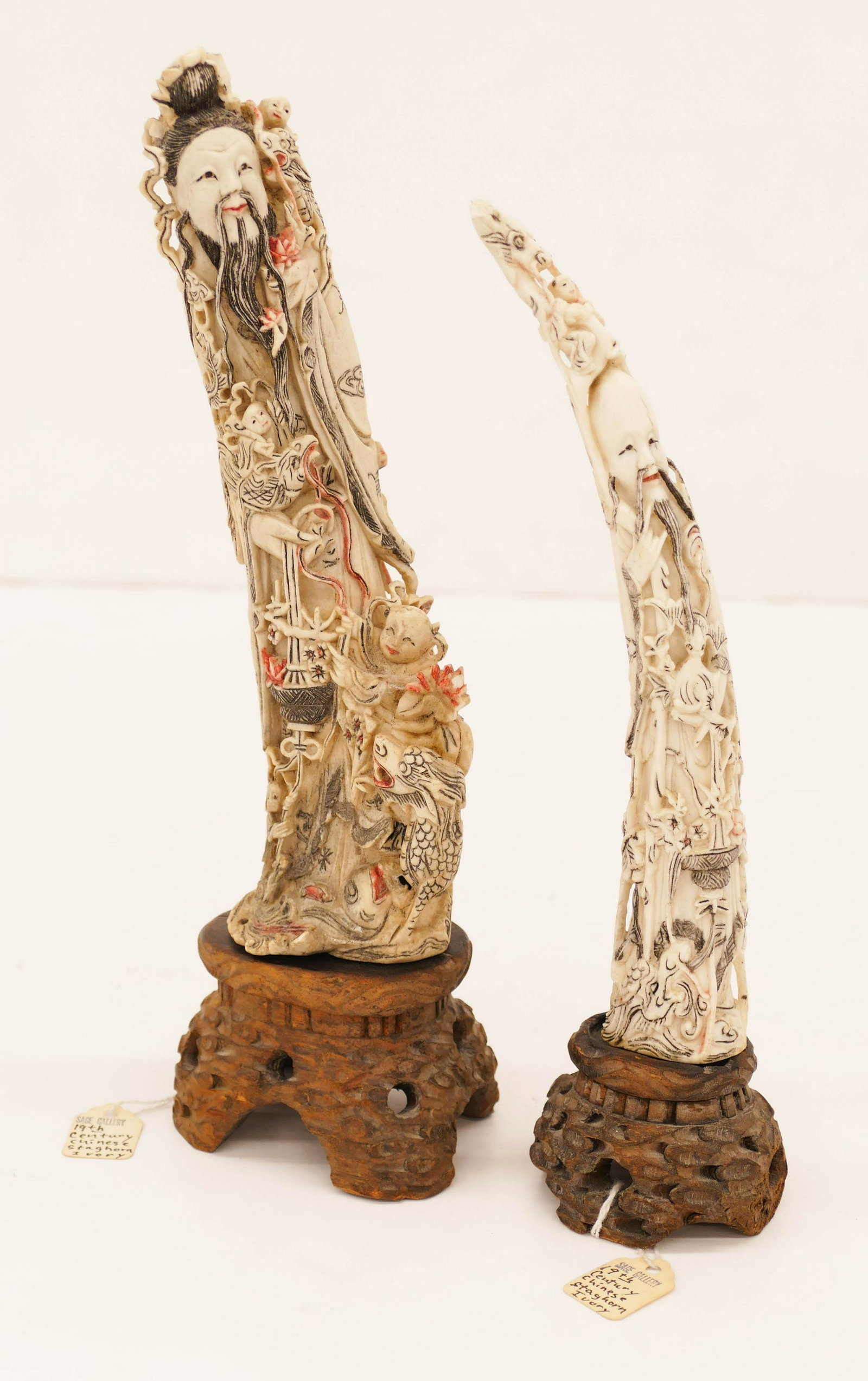 2pc Chinese Qing Staghorn Carvings on Stands 11'' and: 2pc Chinese Qing Staghorn Carvings on Stands 11'' and 9.75''. Polychrome decorated shoulao and deity figure relief carvings. They comes on fitted rosewood stands. A few small chips to top edges. 19th 