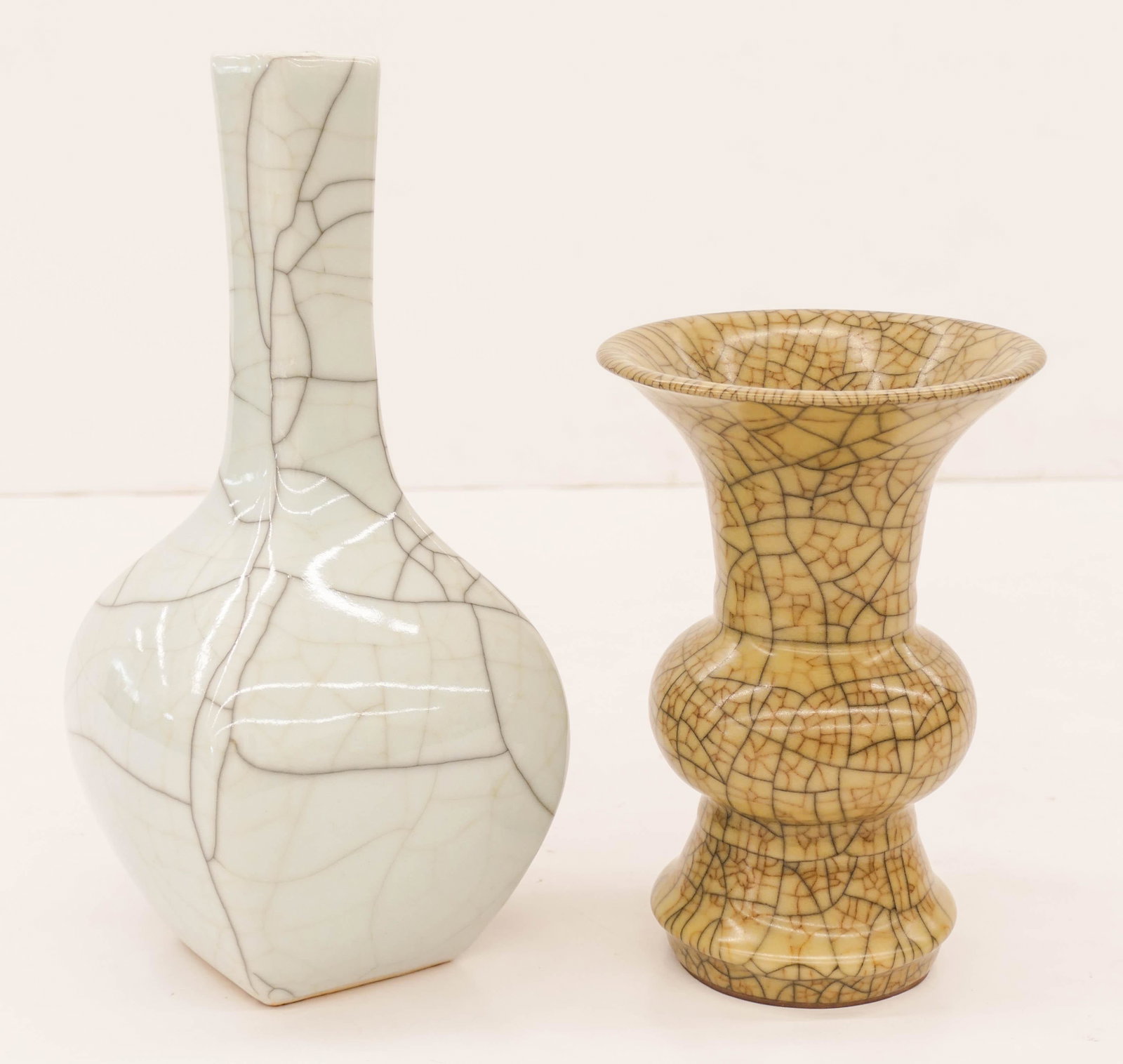 2pc Chinese Geyao Crackle Glaze Porcelain Vases 11.25'': 2pc Chinese Geyao Crackle Glaze Porcelain Vases 11.25'' and 8''. Includes a tall blueish celadon ge crackle vase and a guan type beaker vase. Excellent condition. 20th century.