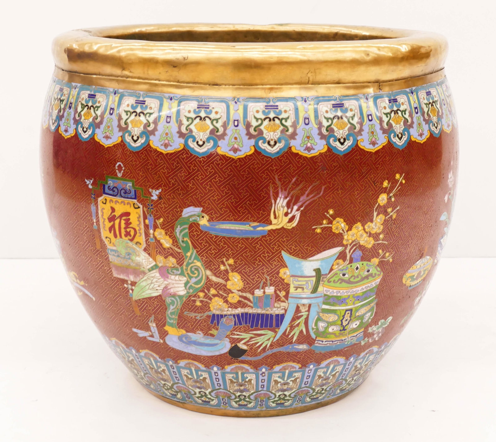 Large Chinese Cloisonne Planter 18.5''x21''. Polychrome: Large Chinese Cloisonne Planter 18.5''x21''. Polychrome enameled with scholarly objects and precious ornaments. A few small dents to top rim. Overall excellent condition. Mid 20th century.