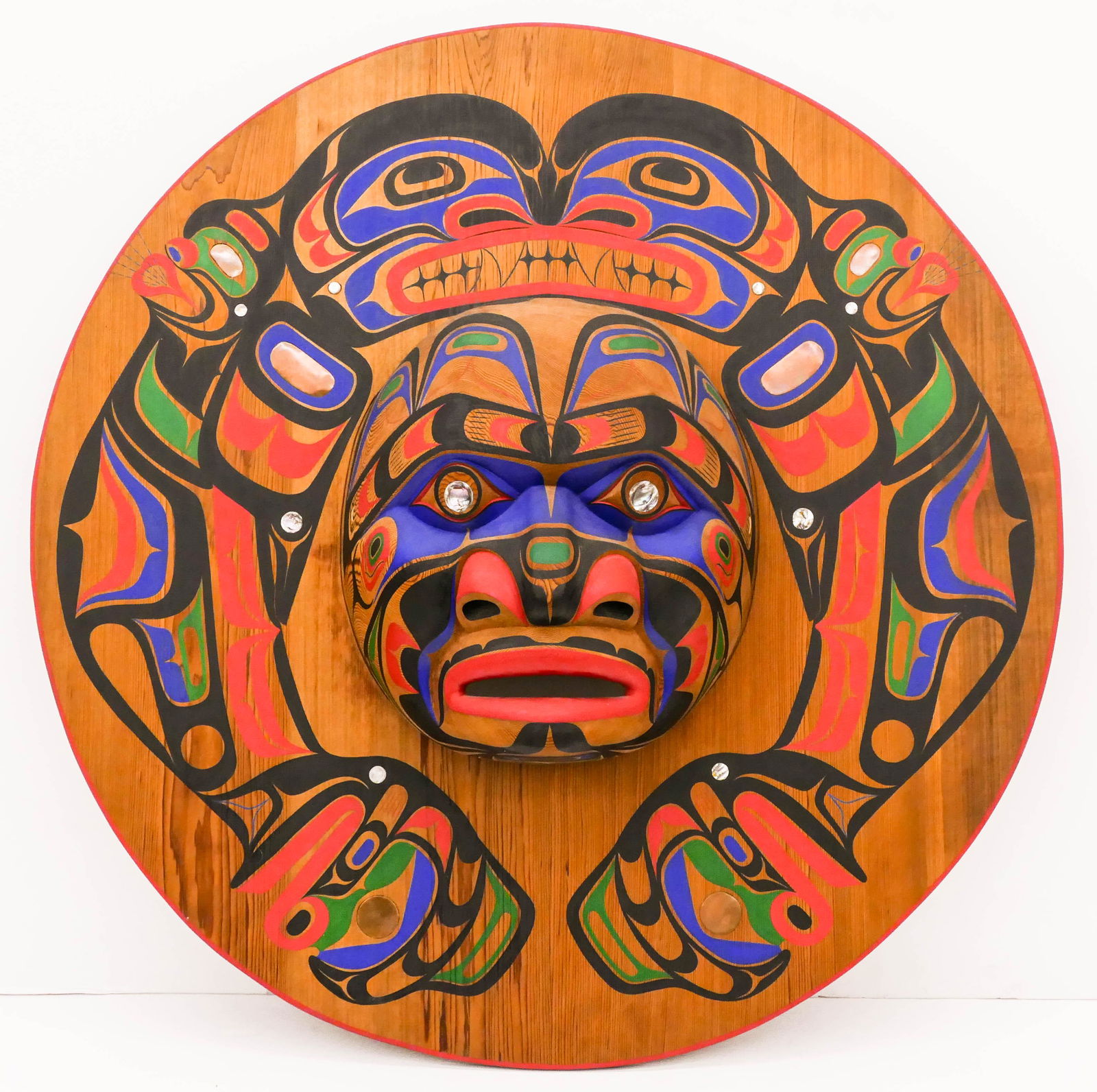 Tom Patterson (b.1962 Nuu-chah-nulth) Massive Kwagiulth: Tom Patterson (b.1962 Nuu-chah-nulth) Massive Kwagiulth Moon Mask 1996 Painted Cedar with Inlays 47.5''x47.5''x10''. Impressive carved cedar wall mask with polychrome painted u-form motifs. Abalone an