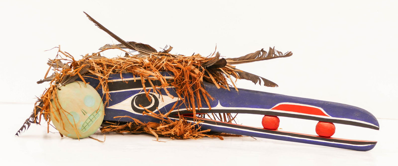 Beau Dick (1955-2017 Kwakiutl) Tanis Mask 1991 Painted: Beau Dick (1955-2017 Kwakiutl) Tanis Mask 1991 Painted Cedar 7''x22''x12''. A polychrome painted carved cedar bird forehead hamatsa mask with berries in mouth and skull rattles at sides. Signed and ti