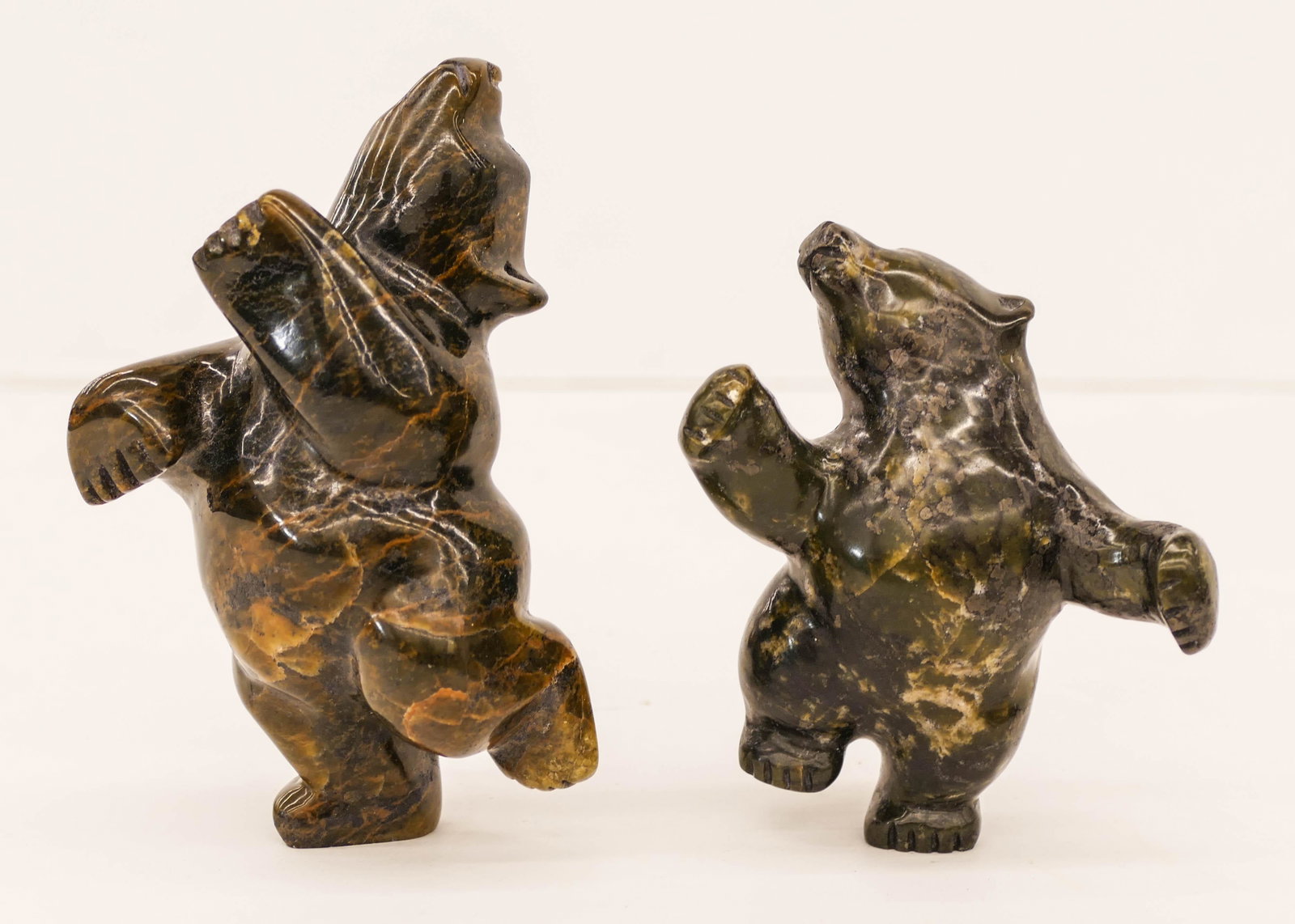 2pc Markoosie Papigatok (b.1976 Inuit) Small Dancing: 2pc Markoosie Papigatok (b.1976 Inuit) Small Dancing Bear Serpentine Sculpture 3.75'' to 5'' Tall. Includes a duo of carved stone upright polar bear figures. Signed on bottom. Purchased Inuit Gallery 