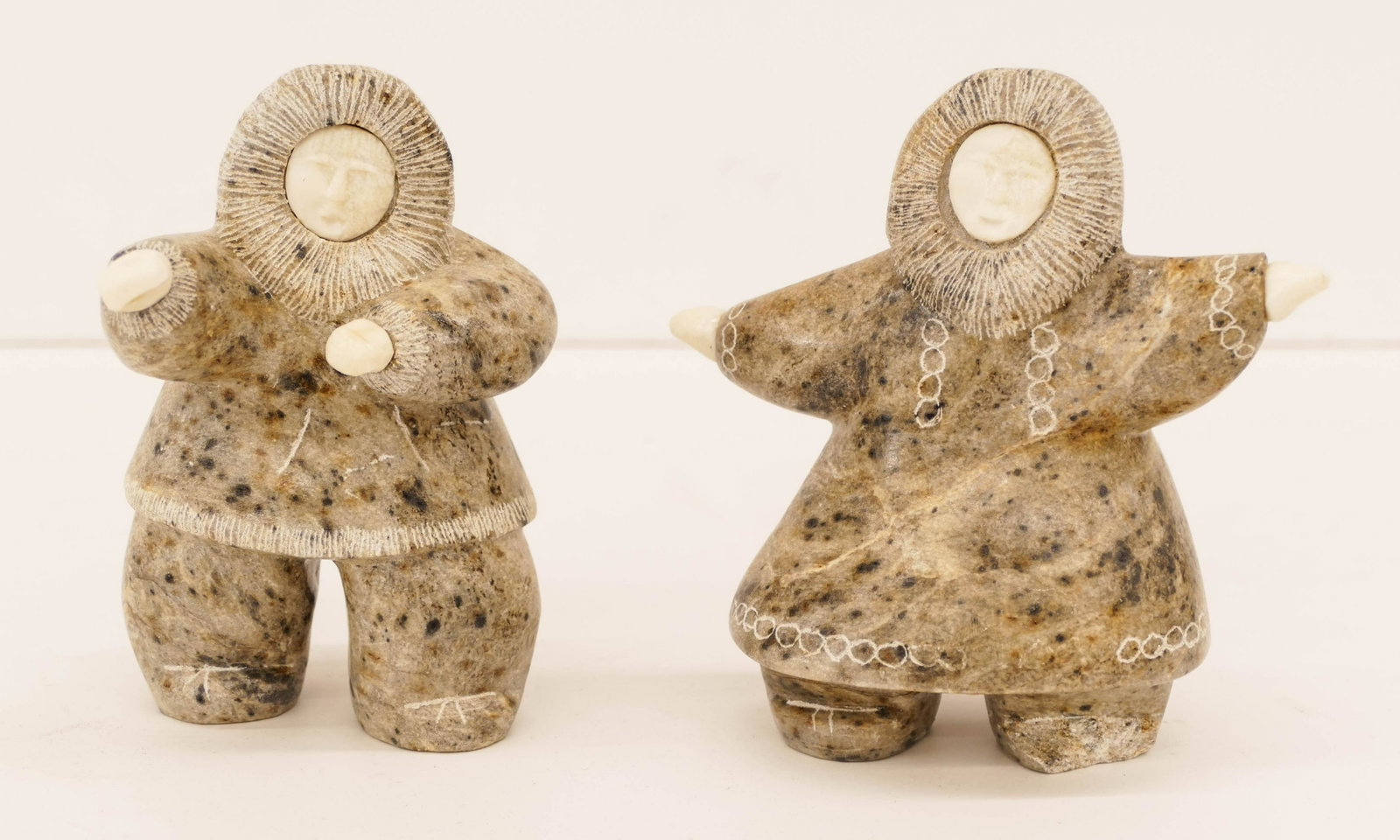 2pc Edith Oktollik (20th Cent. Inuit) Eskimo Dancers: 2pc Edith Oktollik (20th Cent. Inuit) Eskimo Dancers Soapstone Sculptures 5'' Tall. Includes a pair of carved soapstone with applied bone dancers. Signed on bottom Singaolook. Woman has large chip to 