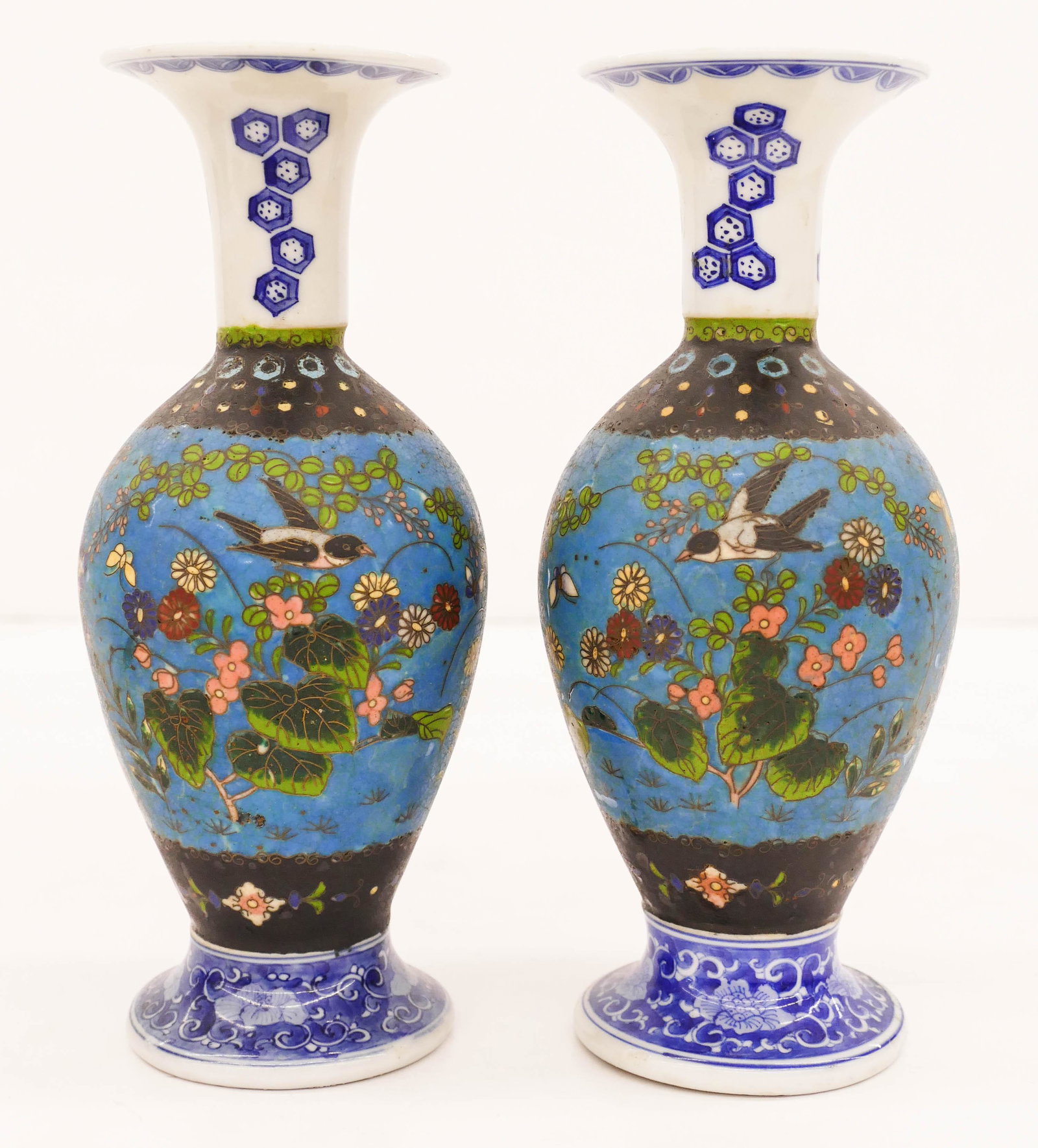 Pair of Japanese Meiji Totai Shippo Vases: Pair of Japanese Meiji Totai Shippo Vases 8.75''x3.5''. A true opposing pair of cloisonne over blue and white porcelain vases with bird and blossoming flower motifs. Single character mark on bottom. E