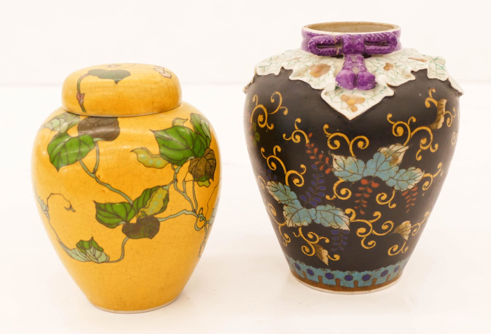2pc Japanese Meiji Totai Shippo Jars 4.75'' to 5.5'': 2pc Japanese Meiji Totai Shippo Jars 4.75'' to 5.5'' Tall. Includes a duo of cloisonne over porcelain jars including a yellow ground ginger jar and a black ground jar with rope design (repair to bow).