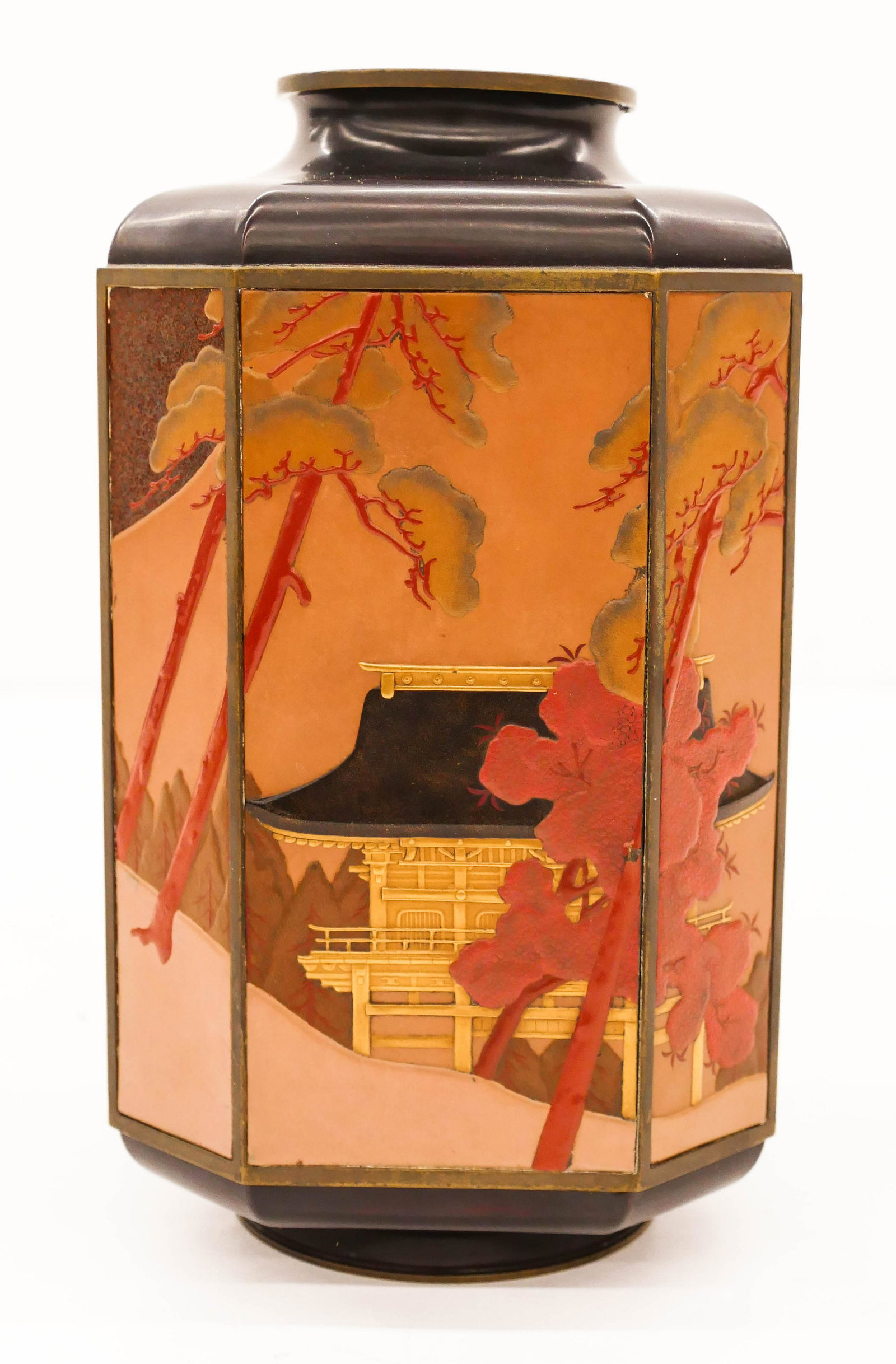 Fine Japanese Meiji Lacquered Metal Octagonal Vase: Fine Japanese Meiji Lacquered Metal Octagonal Vase 8''x4.5''. An intricate polychrome lacquered vase with temple in landscape relief motif that is continuous around the form. Signed in cartouche on si