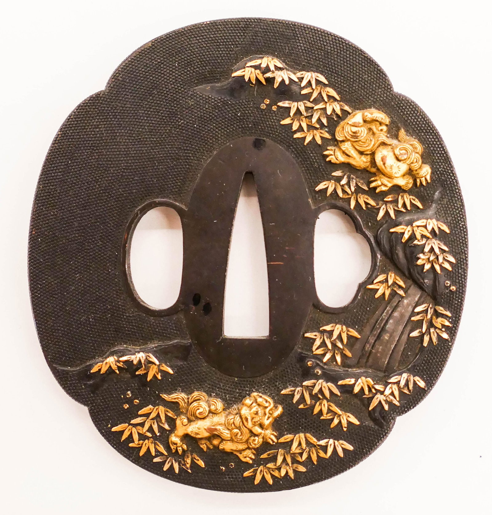 Fine Japanese Meiji Shakudo Foo Dog Tsuba 3''x2.75'': Fine Japanese Shakudo Foo Dog Tsuba 3''x2.75''. Fine inlaid gold tsuba decorated on both sides. Unsigned. 19th century, Meiji era. Collection of W. Gordon Menzies, Seattle.