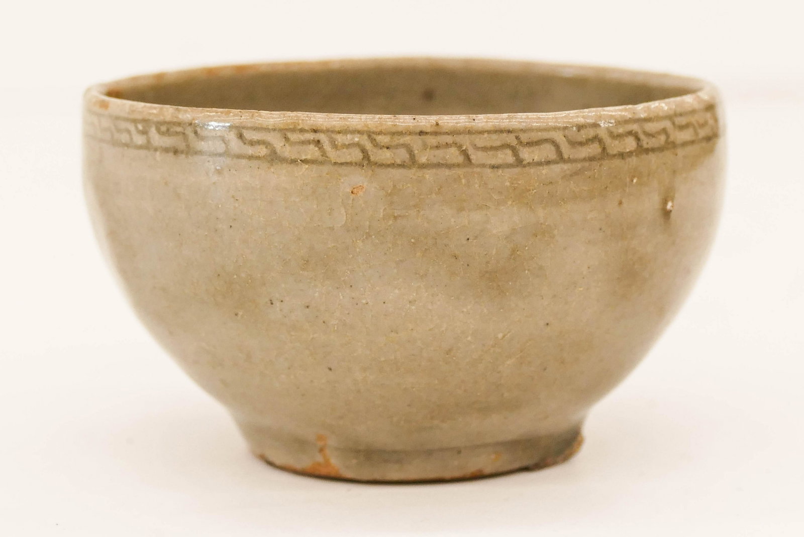 Korean Goryeo Celadon Decorated Rim Small Bowl: Korean Goryeo Celadon Decorated Rim Small Bowl 1.75''x3''. Small ceramic dish with incised repeating decoration around outer rim. Some kiln frit around foot. Excellent condition. 13th century. Collect