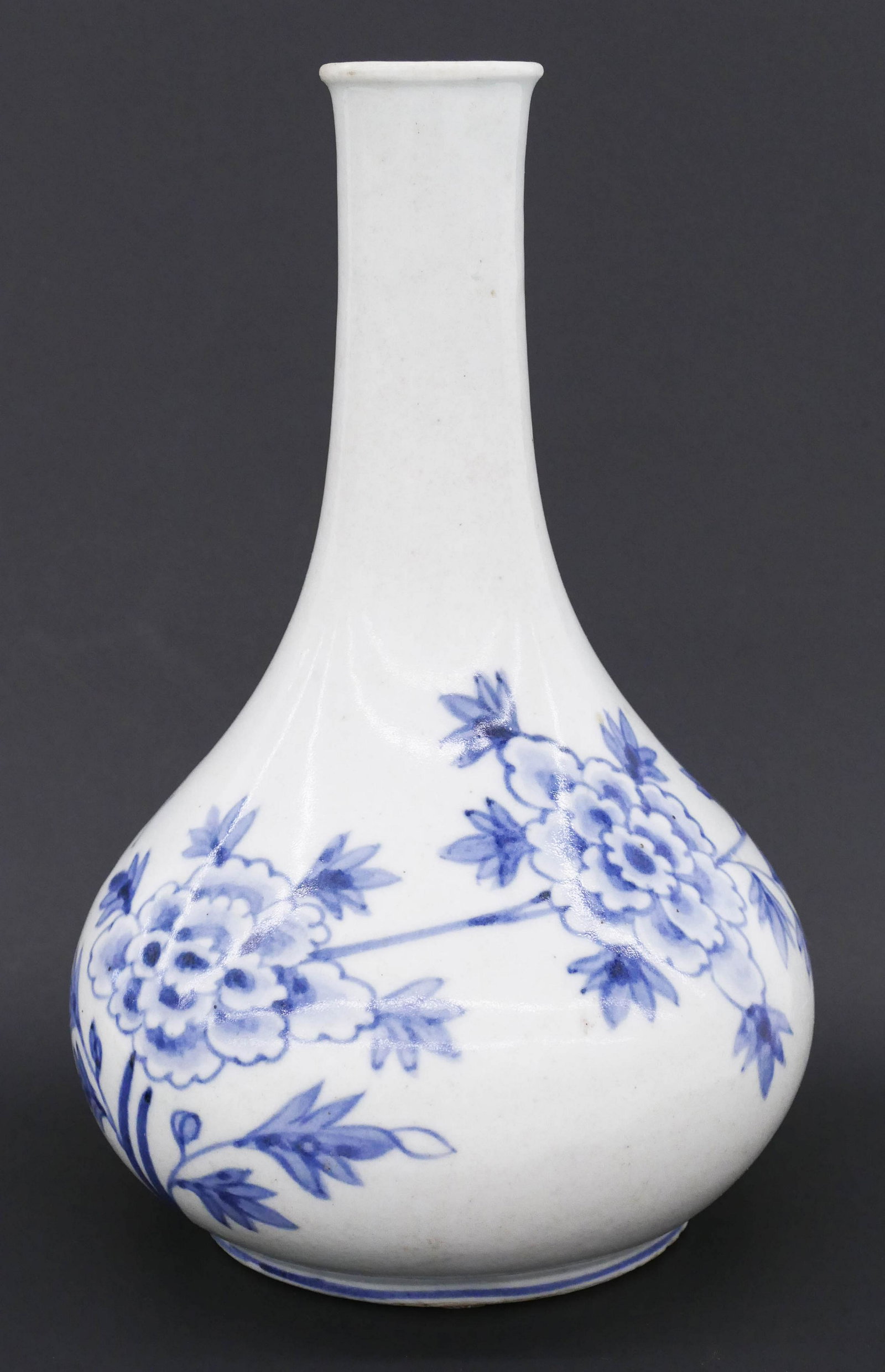 Korean Joseon Blue and White Peony Bottle 9''x5.75'': Korean Joseon Blue and White Peony Bottle 9''x5.75''. A blue underglaze porcelain bottle with peony and bat motif. Old chip repair to top rim. 19th century. Collection of W. Gordon Menzies, Seattle.