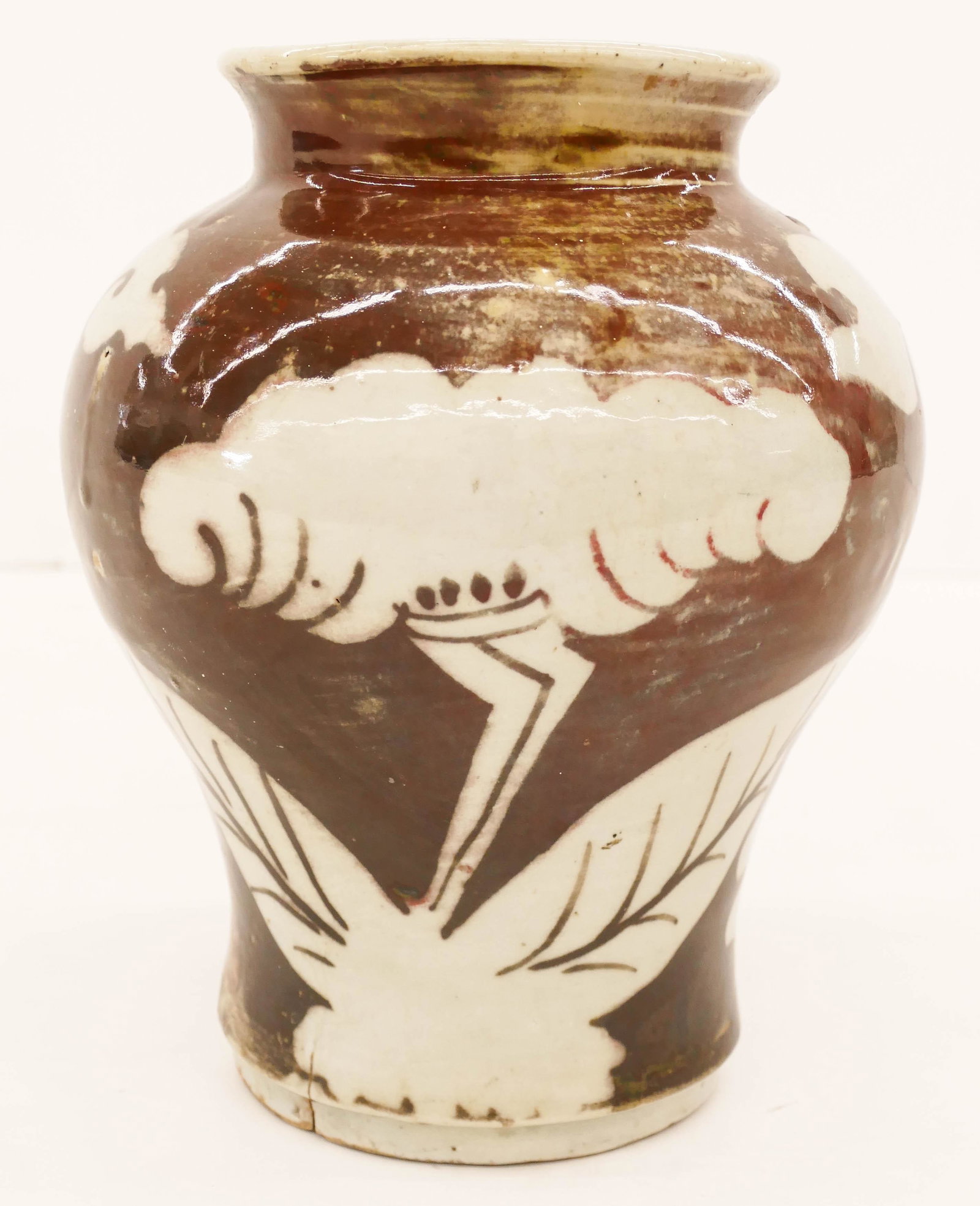Korean Joseon Iron Brown Floral Jar 9''x7'': Korean Joseon Iron Brown Floral Jar 9''x7''. Unusual iron-brown decorated white porcelain jar with stylized flower and cloud motifs. Two small firing cracks on bottom rim, original to manufacture. Exc