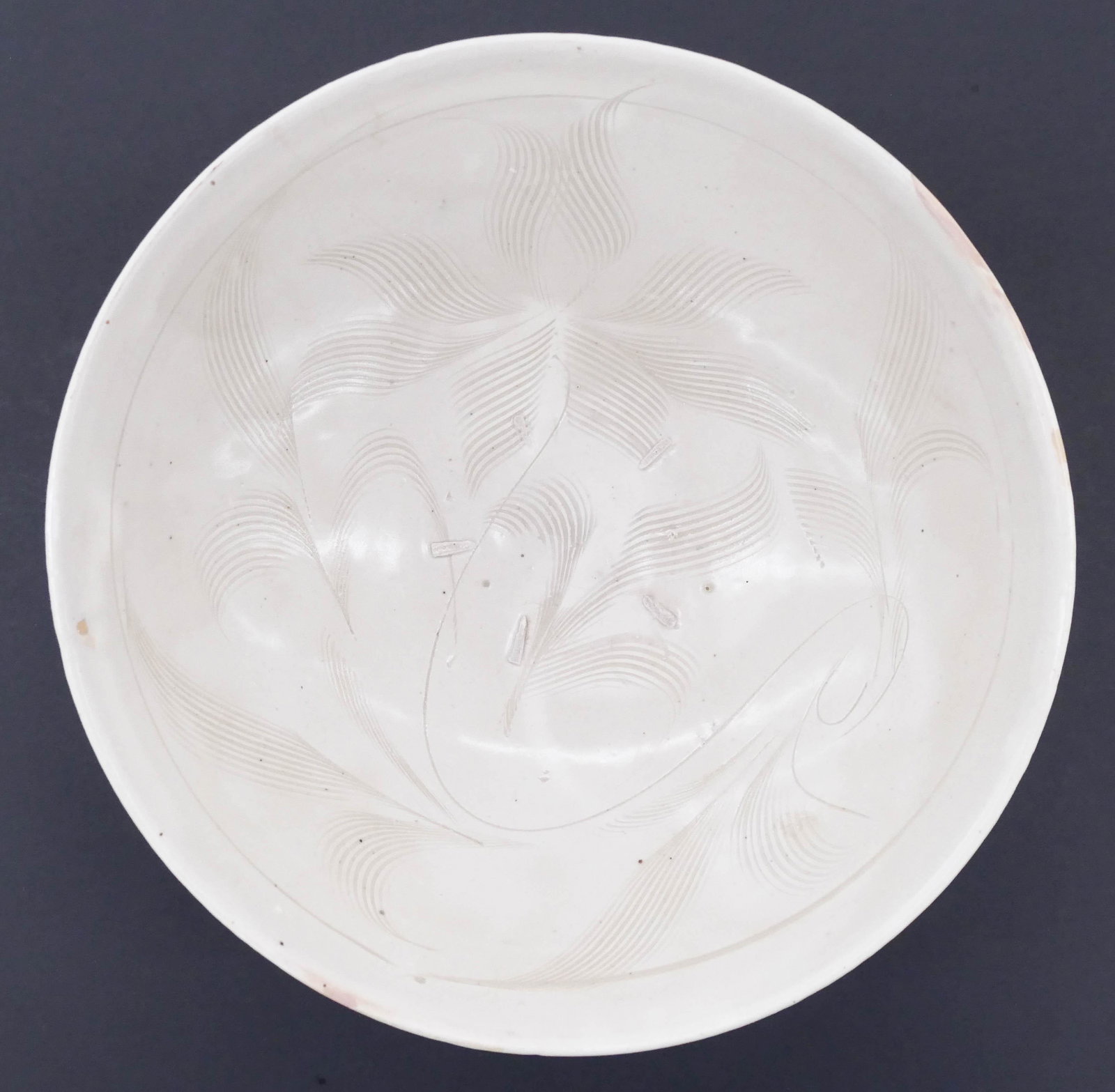 Chinese Song Cizhou White Lotus Bowl 3''x8.5'': Chinese Song Cizhou White Lotus Bowl 3''x8.5''. A scarce ceramic bowl with sgraffito brush carved lotus flower motif. Five spur marks on interior. Several small professional chip/flake repairs to top 