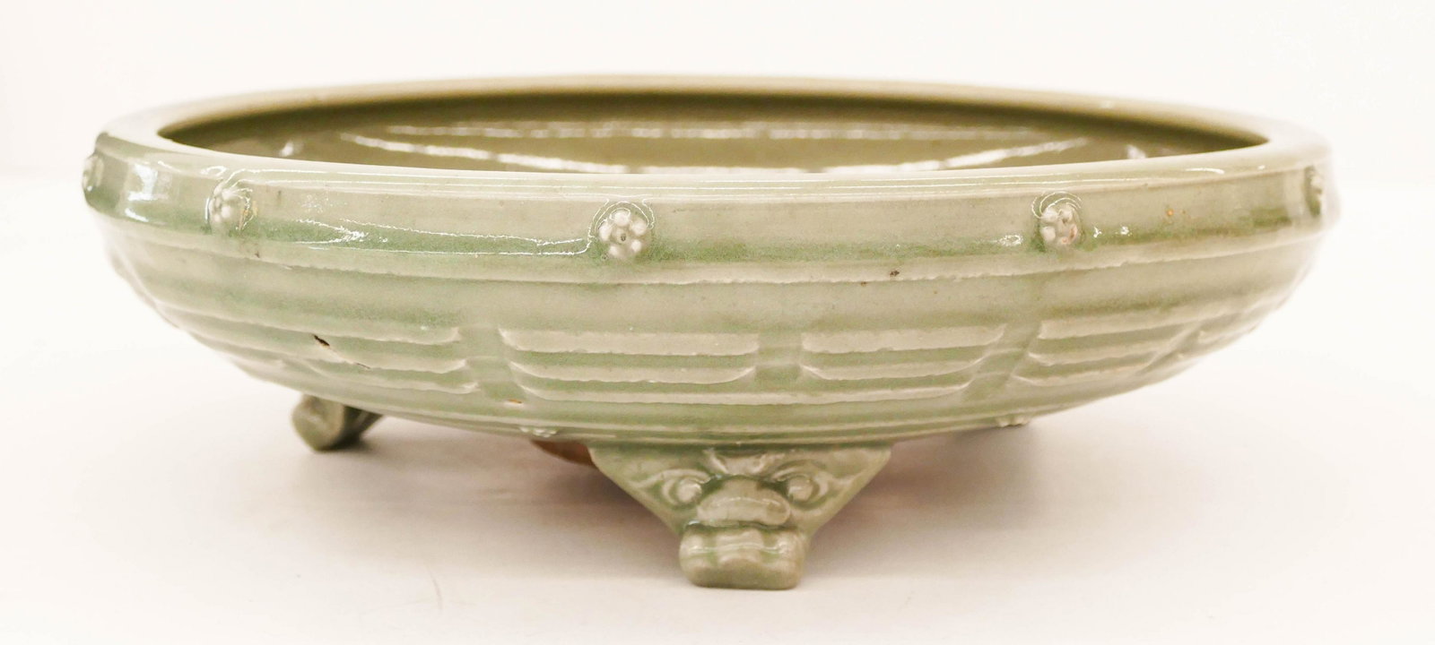 Chinese Yuan Longquan Large Tripod Censer: Chinese Yuan Longquan Large Tripod Censer 3.75''x12.5''. A large ceramic celadon censer with the buddhist trigrams on sides. Impressed floral motif in center. Excellent condition. 13th or 14th century