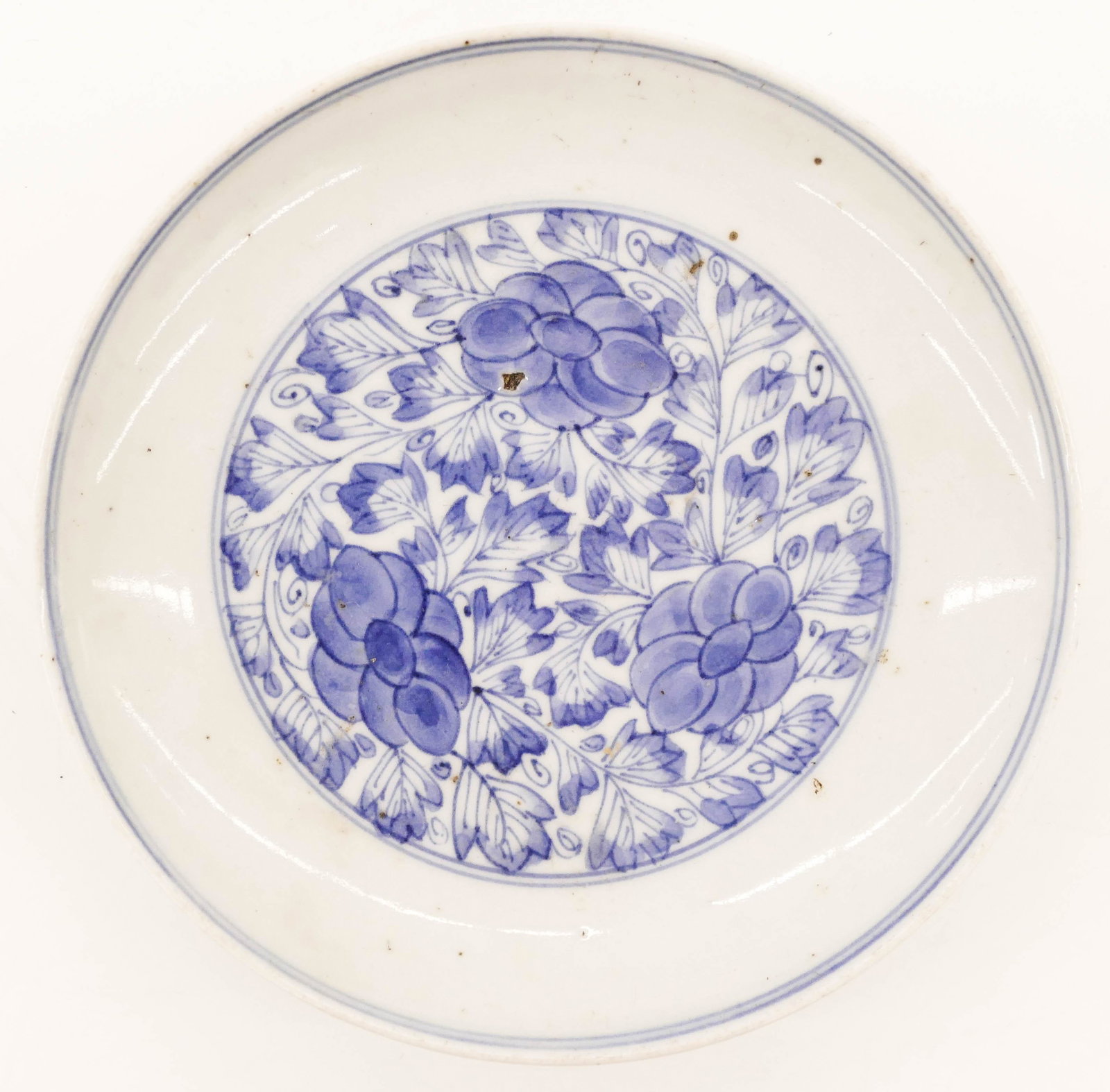 Chinese Kangxi Blue and White Peony Dish 5.75'': Chinese Chenghua Blue and White Peony Dish 5.75''. A porcelain dish with scrolling peony flower motif. Six character mark. A few slight flakes to foot interior. 17th century, Ming dynasty. Collection 