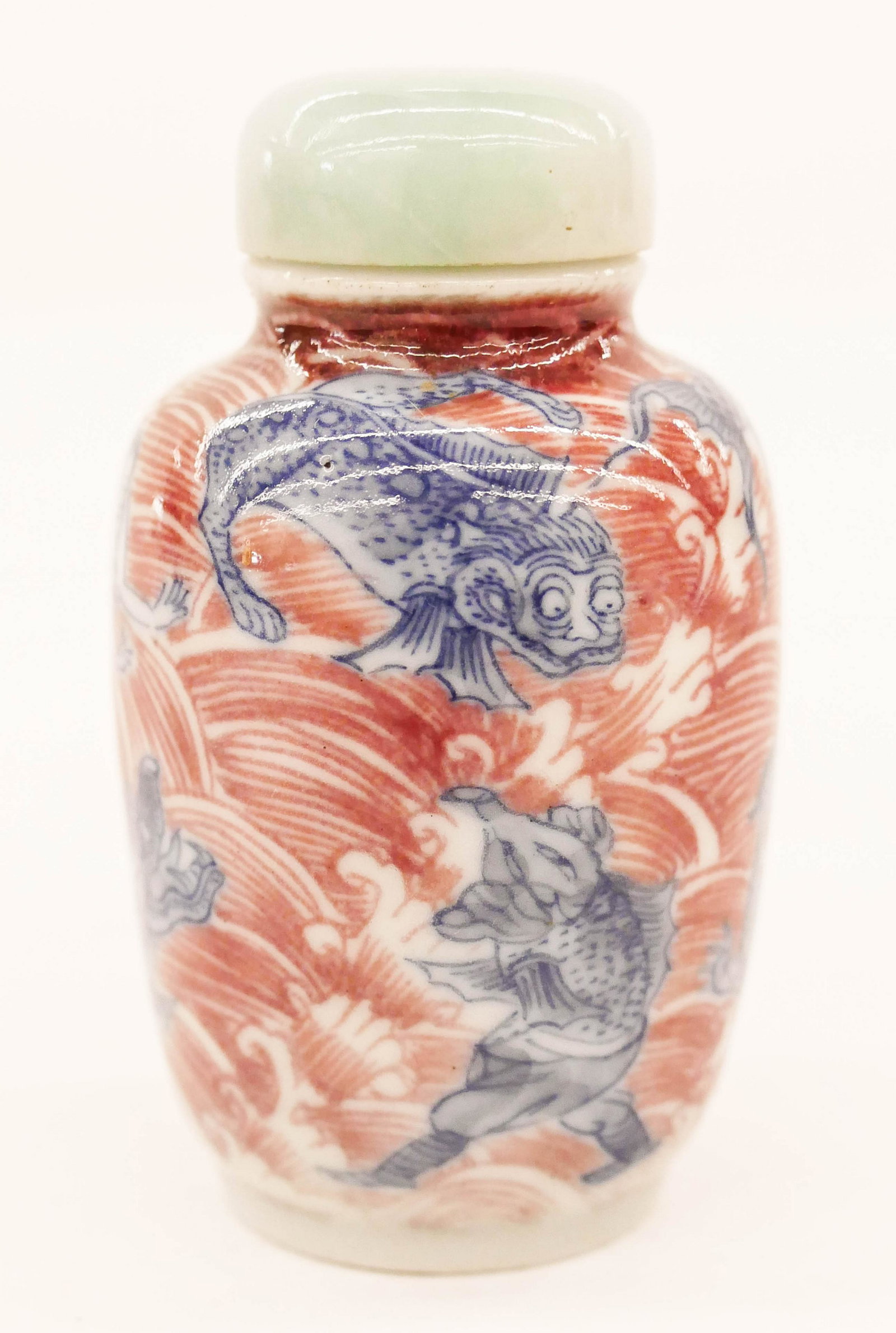 Chinese 18th Cent. Copper Red Snuff Bottle: Chinese 18th Cent. Copper Red Snuff Bottle 2.75''x1.5''. Exceptional blue and copper red decorated wide snuff with various mythological beasts. Unmarked. Jadeite apple green to white stopper. Well hol