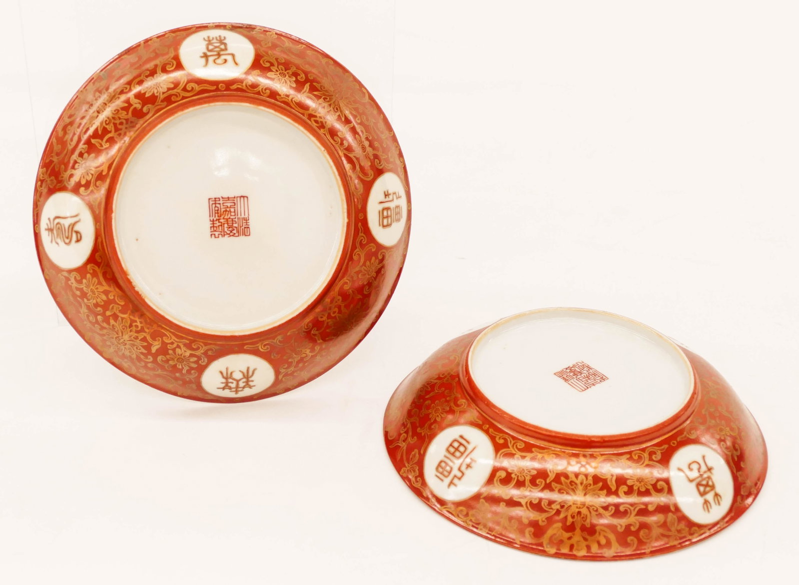 Pair of Chinese Jiaqing Gilt Coral Ground Dishes: Pair of Chinese Jiaqing Gilt Coral Ground Dishes 6.25''x1.25''. Matched pair depicting four roundels of characters ''Jia Zi Wan Nian'' with central bat and shou motifs. Red enameled seal marks and of 