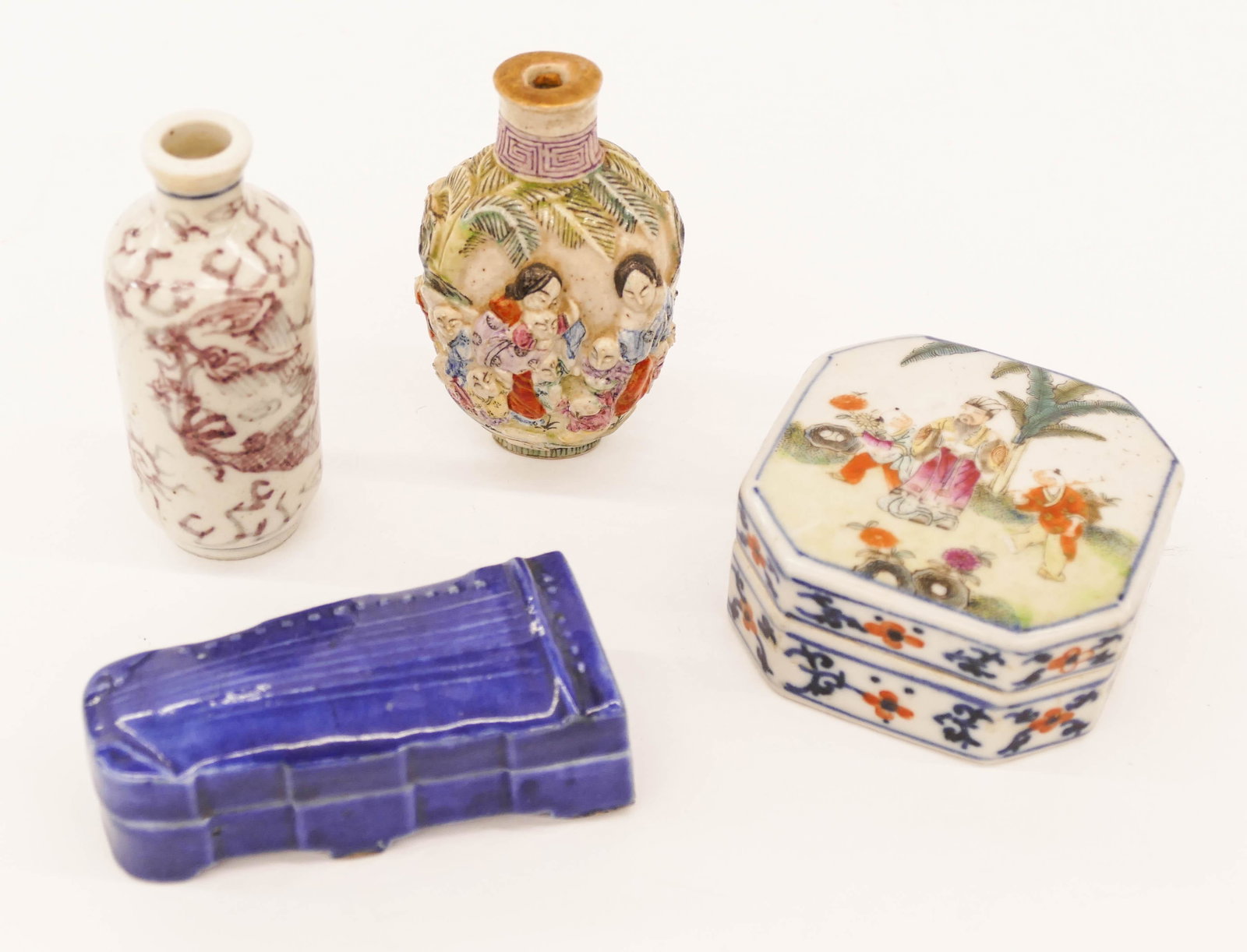 4pc Old Chinese Porcelain Snuff Bottles and Ink Boxes: 4pc Old Chinese Porcelain Snuff Bottles and Ink Boxes 2.5'' to 3''. Includes a molded figure snuff bottle, a copper red dragon snuff, a figural guzheng instrument blue box, and a famille rose square b