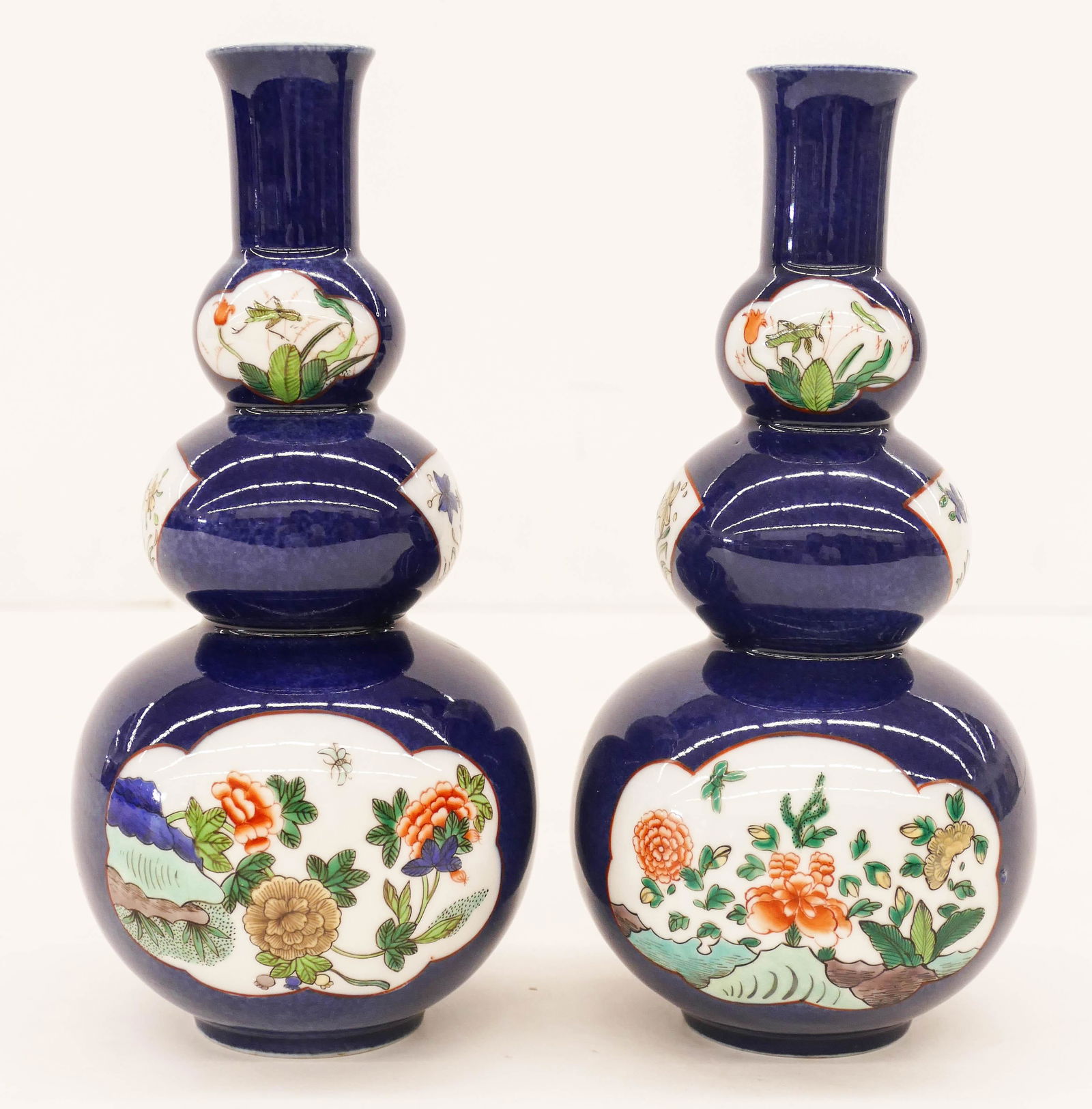 Pair of Chinese Qing Powder Blue Double Gourd Vase: Pair of Chinese Qing Powder Blue Double Gourd Vases 8.5''x4''. A pair of Kangxi-style famille verte decorated porcelain vases with flower and insect motifs. Blue Artemisia leaf mark. Excellent conditi