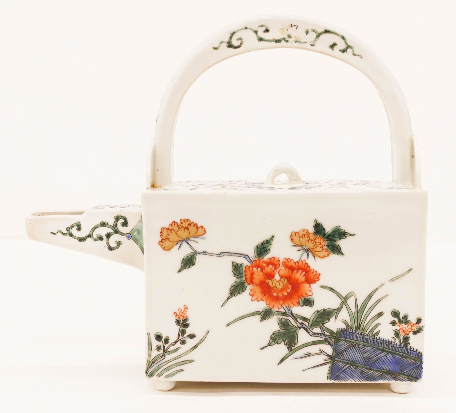 Japanese Edo Kakeimon Choshi Sake Ewer: Japanese Edo Kakeimon Choshi Sake Ewer 8''x8.5''x2.75''. Unusual square form porcelain ewer with fixed bail. Polychrome enameled with blossoming peony and chrysanthemum flowers. Some wear to enamel on