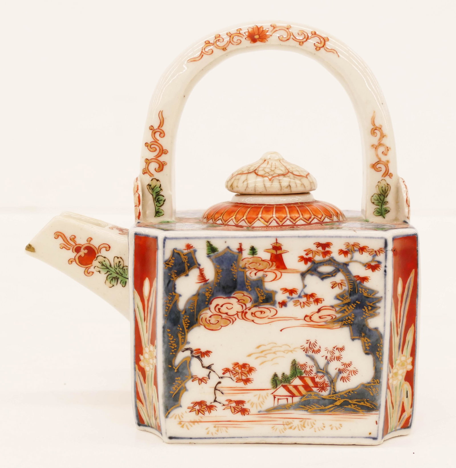 Japanese Edo Imari Small Choshi Kettle: Japanese Edo Imari Small Choshi Kettle 5.25''x5.5''x3''. A polychrome enameled gilt decorated porcelain kettle with fixed bail. Landscape motifs with shou symbols on top. Small kintsugi chip repair to