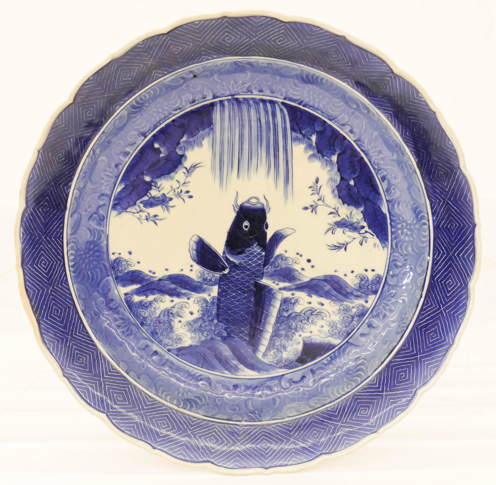Japanese Meiji Arita Sometsuke Carp Charger 16''x3'': Japanese Meiji Arita Sometsuke Carp Charger 16''x3''. Unusual large blue and white porcelain charger with foliate rim. Excellent condition. 19th century. Estate of Margaret Flagg, Maryland.