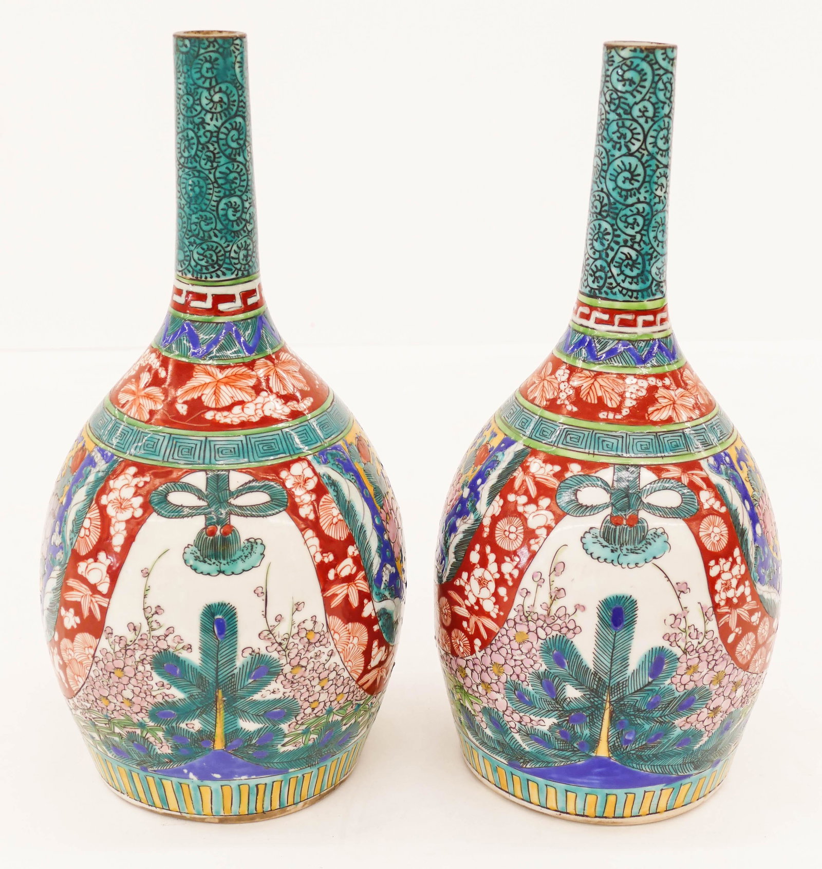 Pair Japanese Meiji Kutani Tokkuri Bottles 12.75'': Pair Japanese Meiji Kutani Tokkuri Bottles 12.75''x6.25''. Unusual pair of matching porcelain sake bottles with polychrome floral motifs. Octopus patterns on spout. Excellent condition. 19th or early 