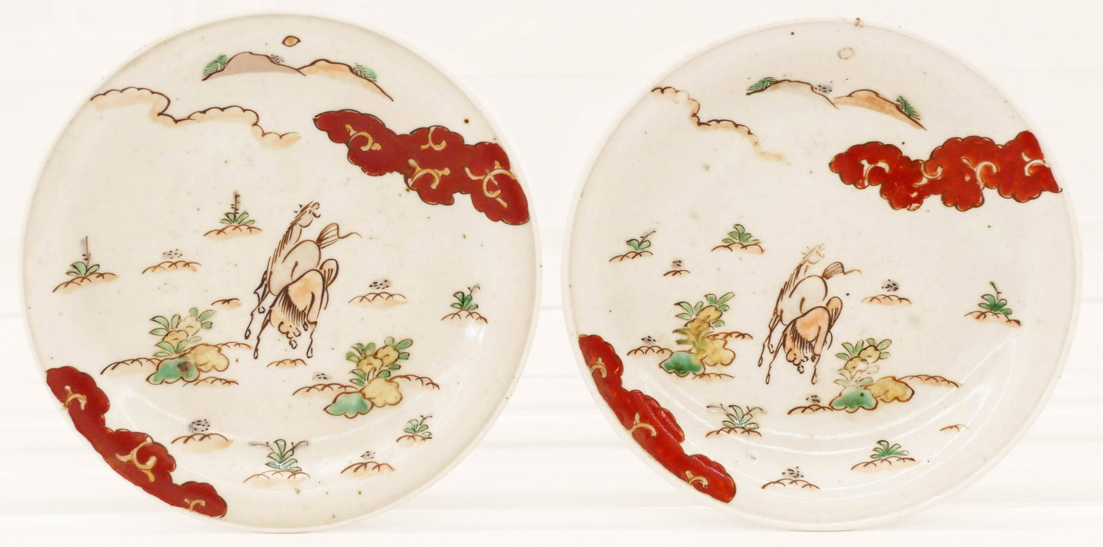 Pair Japanese 18th Cent. Kutani Horse Dishes 6.75'': Pair Japanese 18th Cent. Kutani Horse Dishes 6.75''. A pair of polychrome enameled porcelain small plates with horse in landscape motifs. Some surface wear from use. Edo period. Collection of W. Gordo