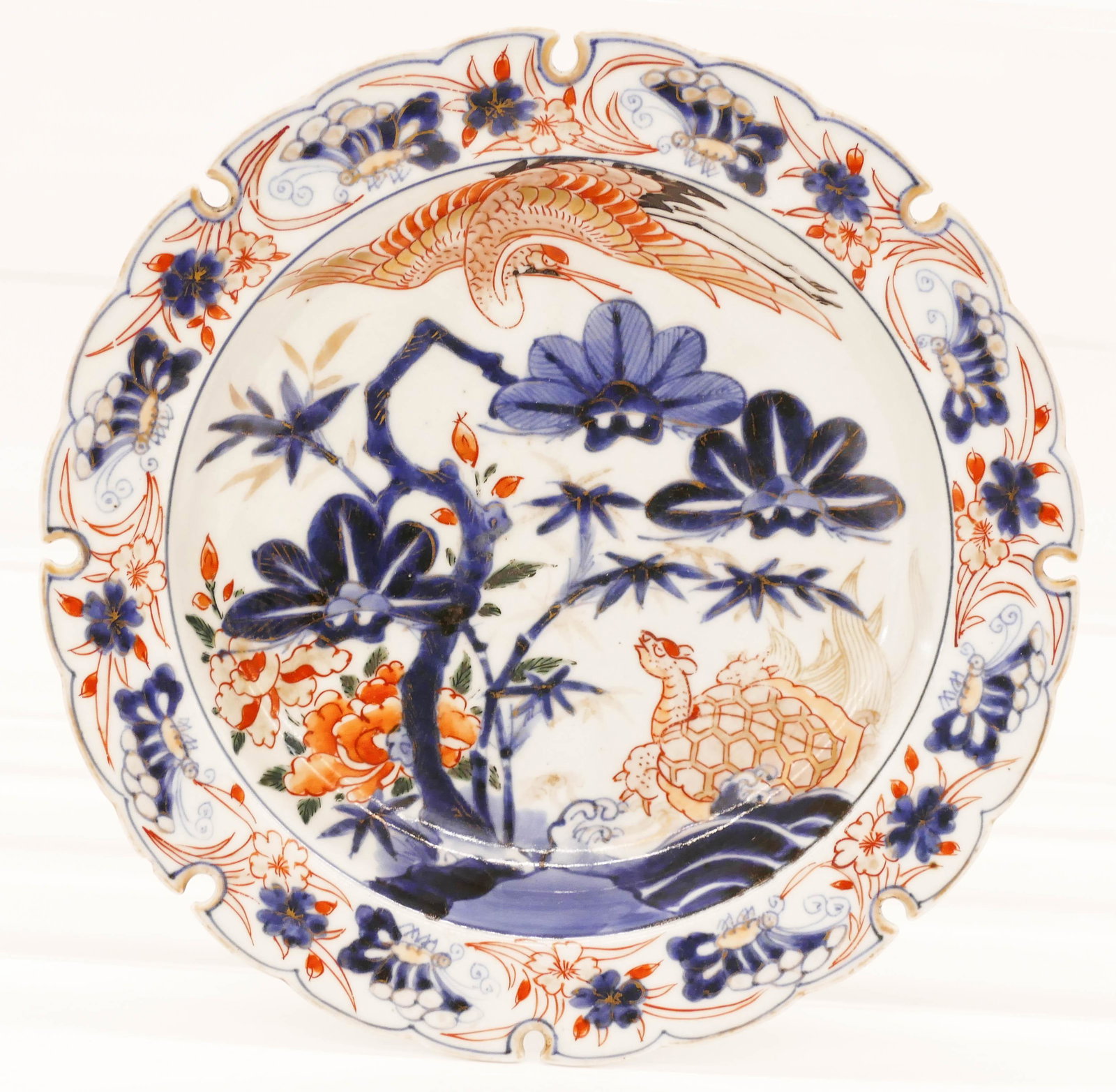 Japanese 18th Cent. Imari Serrated Rim Deep Plate: Japanese 18th Cent. Imari Serrated Rim Deep Plate 8.5''x1.5''. Unusual cut rim porcelain dish with crane and turtle gilt motifs. One small edge chip on verso. Edo period. Collection of W. Gordon Menzi