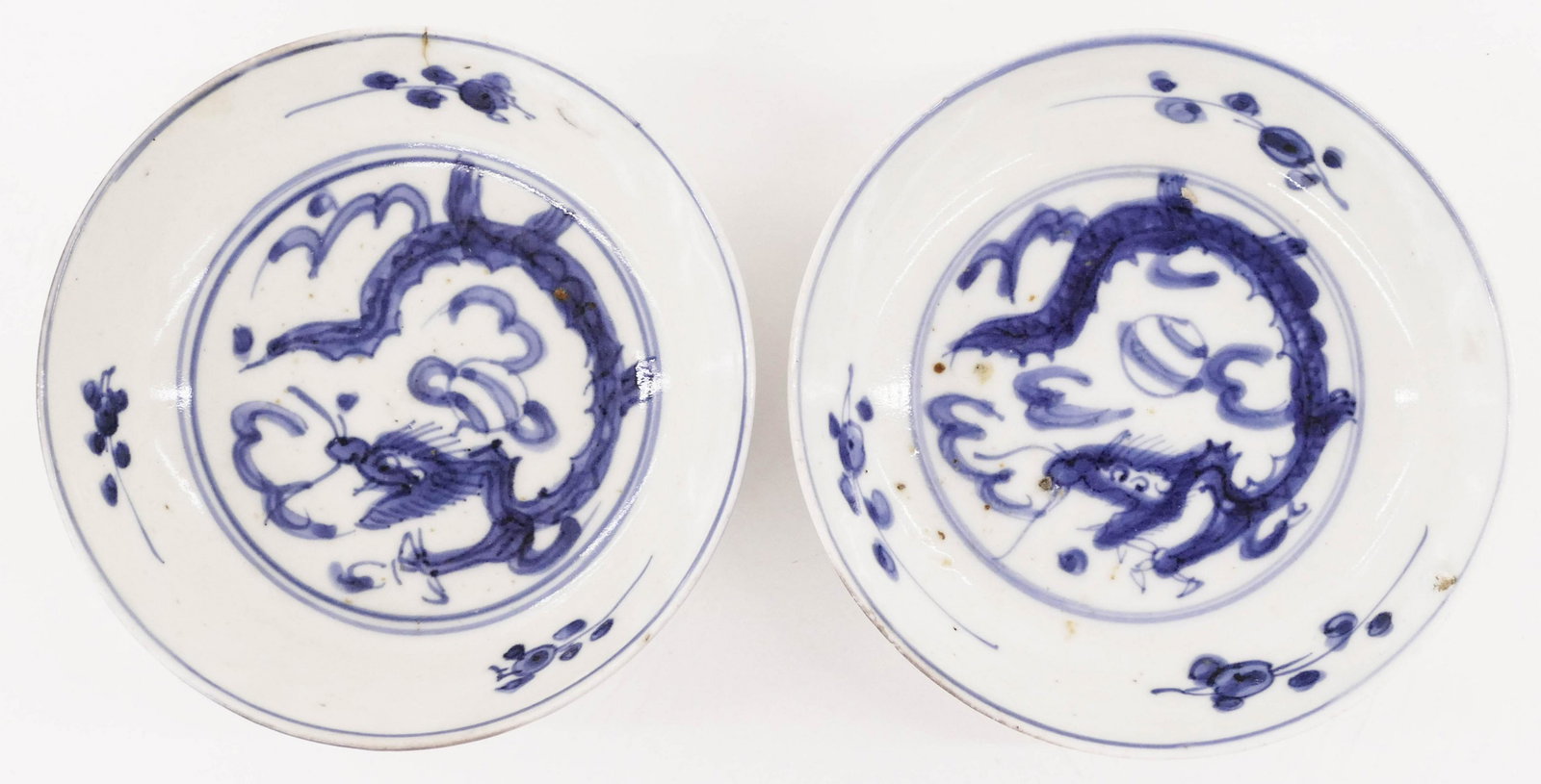 Pair Japanese 17th Cent. Dragon Swatow Dishes: Pair Japanese 17th Cent. Dragon Swatow Dishes 1.5''x4.75''. A duo of early blue and white porcelain sometsuke low bowls with dragon motifs. One has a slight hairline. Edo period. Collection of W. Gord