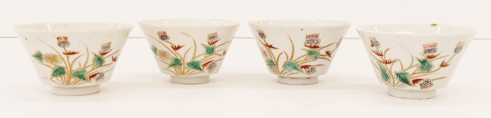 Set 4 Japanese Edo Kutani Poppy Tea Bowls: Set 4 Japanese Edo Kutani Poppy Tea Bowls 2.5''x4.75''. Unusual set of polychrome enameled conical tea bowls with gilt poppy motifs. Two have small kintsugi edge chip repairs. Late 18th or early 19th