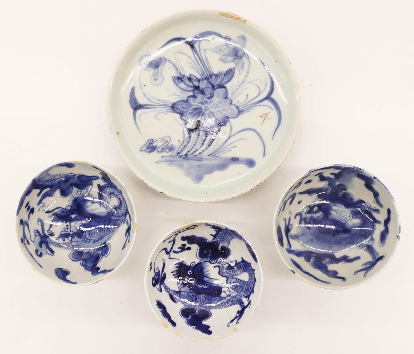 4pc Chinese Export Blue de Hue Vietnamese Porcelain: 4pc Chinese Export Blue de Hue Vietnamese Porcelain. Includes a blue and white lotus and duck tea tray 6.25'' and three dragon tea cups 1.75''x3.75''. The tray has and old edge chip repair with a few 