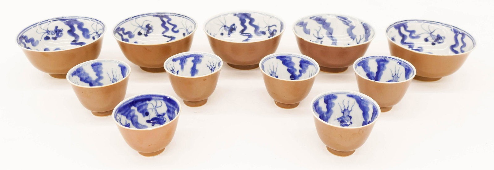 11pc Chinese Qing Export Batavia Ware Porcelain: 11pc Chinese Qing Export Batavia Ware Porcelain. Includes a group of five cafe au lait blue and white tea bowls 2.25''x4.75'' and a set of six wine cups 2''x2.75''. Excellent condition. 18th or 19th c