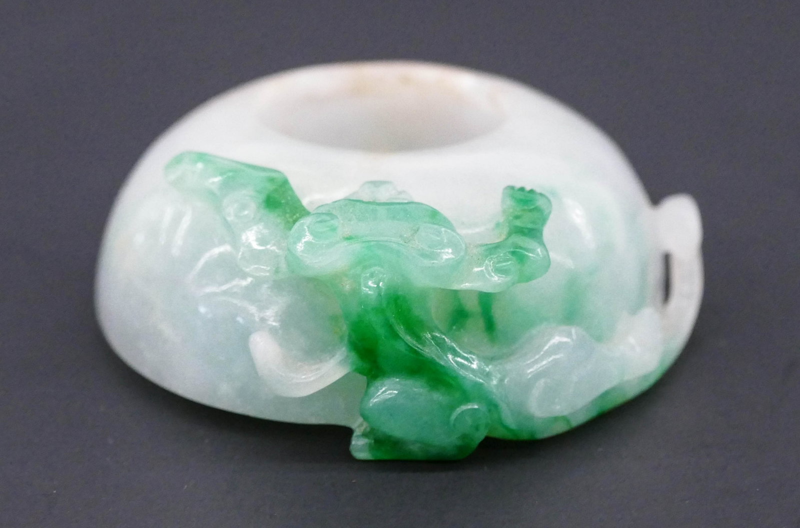 Old Chinese Jadeite Qilin Water Coupe: Old Chinese Jadeite Qilin Water Coupe 1''x2.25''. A white to apple green jade carved small brush washer with pierced qilin motif. Slight edge roughness to rim. 20th century. Collection of W. Gordon Me
