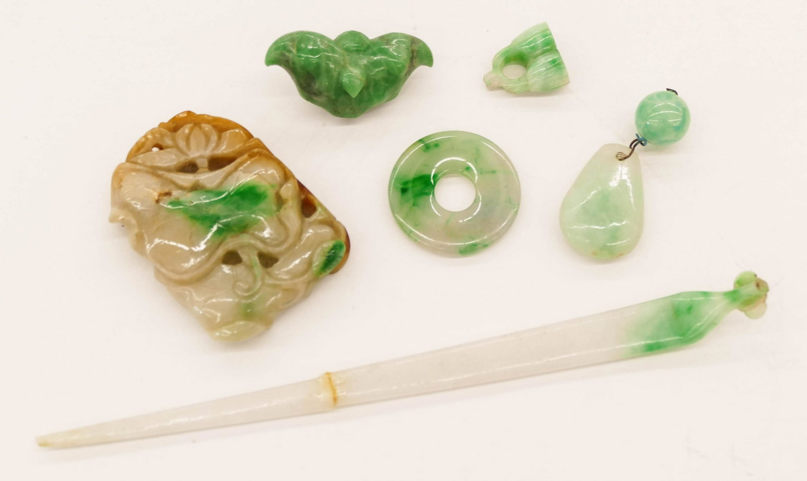 4pc Chinese Qing Jadeite Jewelry .5'' to 5.5'': 6pc Chinese Qing Jadeite Jewelry .5'' to 5.5''. Includes four pieces of white to apple green jadeite jewelry including a lotus pendant with russet splash, a hair pin (broken), a bi disc, and three sma