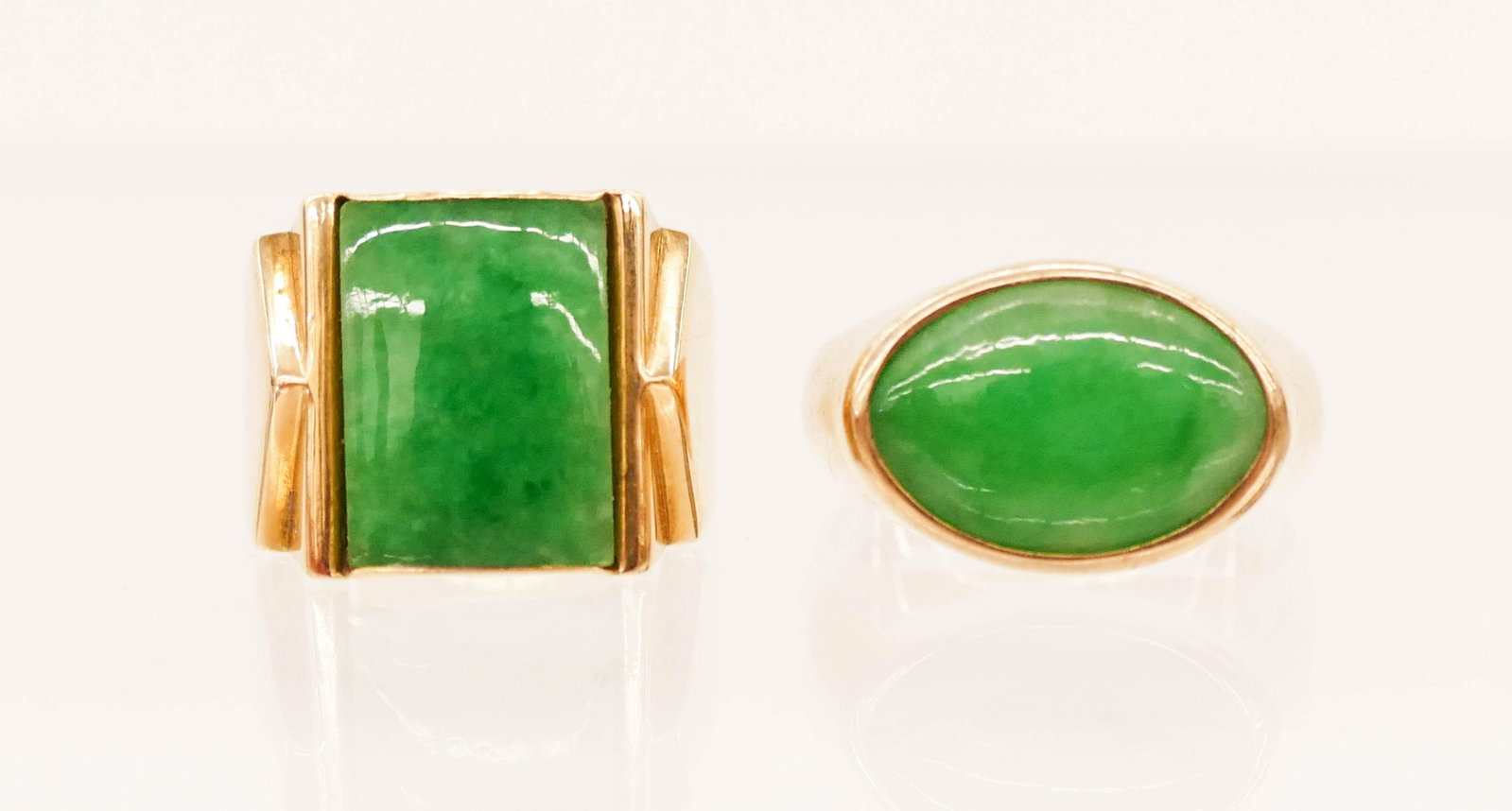 2pc Vintage 14k Jadeite Rings: 2pc Vintage 14k Jadeite Rings. Includes a duo of apple green jade rings. One has a square panel 13.5x10mm, size 7. The other has an oval cabochon 10x14.5mm, size 8. Unmarked, but tested. Group weighs 
