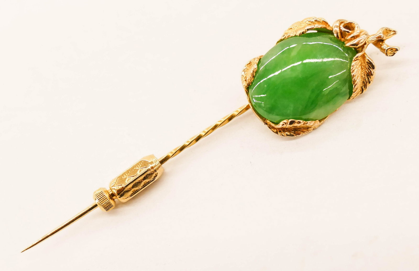 Fox's 14k Jadeite Apple Stick Pin 2.75'': Fox's 14k Jadeite Apple Stick Pin 2.75''. A custom 14k gold mounted apple green jade cabochon 19x15mm. Marked 14K with a ''G'' maker's monogram. It weighs 5.6 grams. Comes with original box and receip