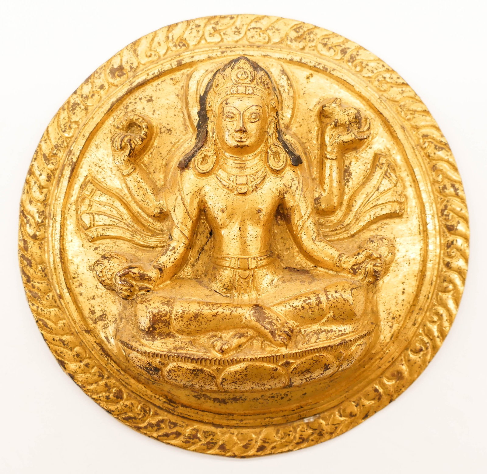 Nepal 18th Cent. Gilt Copper Vishnu Repousse Plaque: Nepalese 18th Cent. Gilt Copper Vishnu Repousse Plaque 5''x1''. A deep repousse plaque with seated vishnu motif in mandala from Nepal. Some scattered surface wear from age. Collection of W. Gordon Men