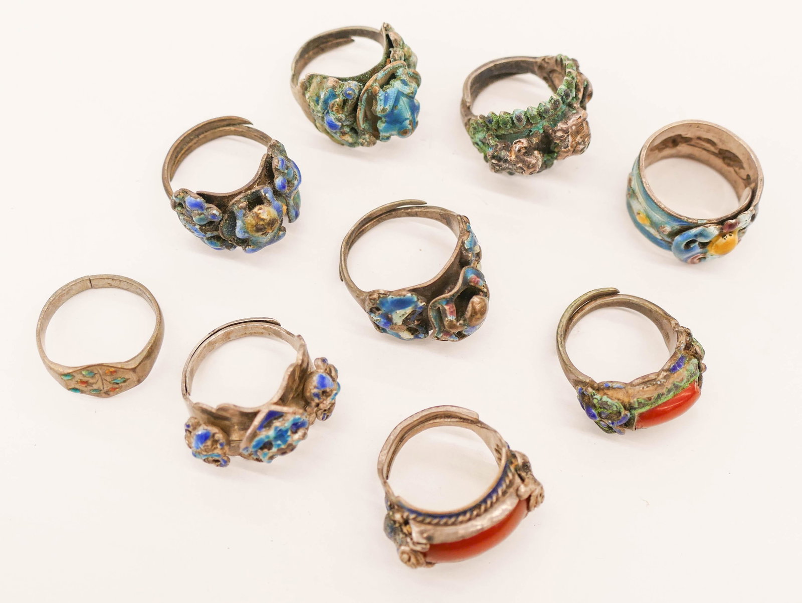 9pc Chinese Qing Enameled Silver Rings: 9pc Chinese Qing Enameled Silver Rings. Includes adjustable children's rings with enameled animals and bat symbols. One has a carnelian cabochon in center. Group weighs 57.8 grams total. Some surface 