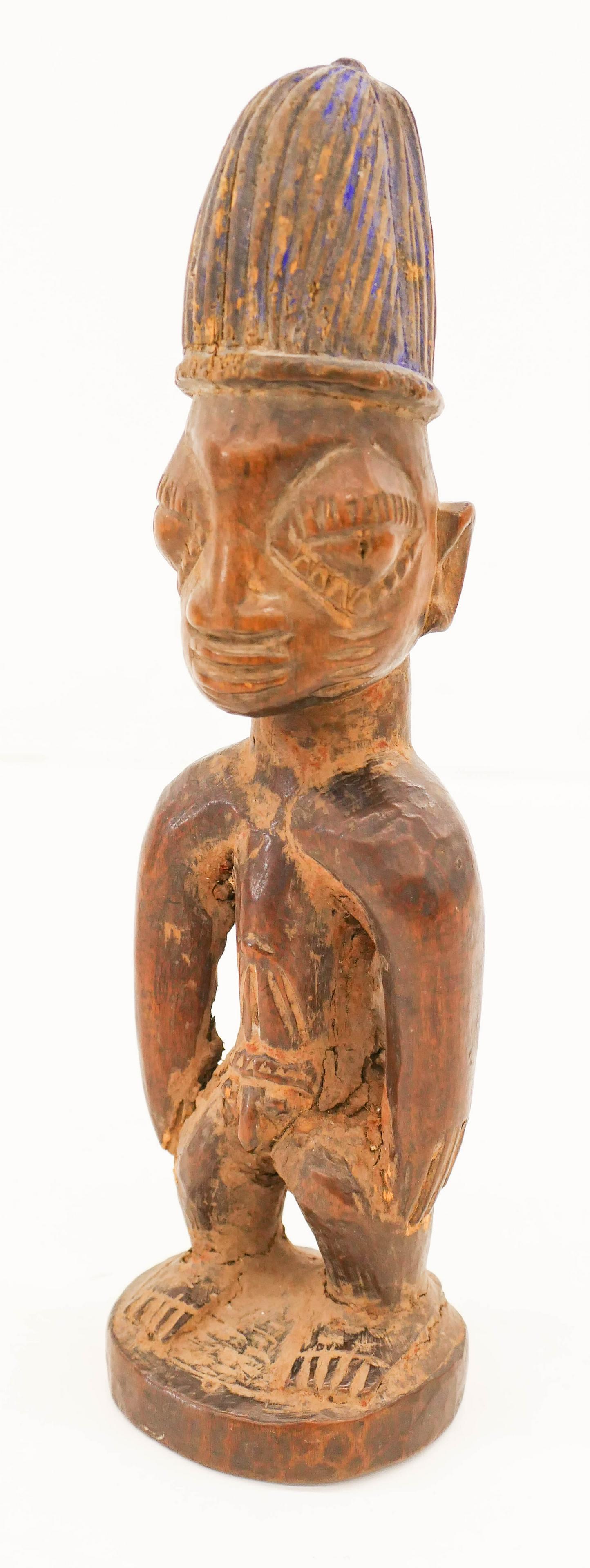 Antique Yoruba Ibeji Male Twin Figure: Antique Yoruba Ibeji Male Twin Figure 11''x3''. A Nigerian carved wood male figure with remnants of blue paint on head. Old repairs and termite damage to body. 19th or early 20th century, African. Col