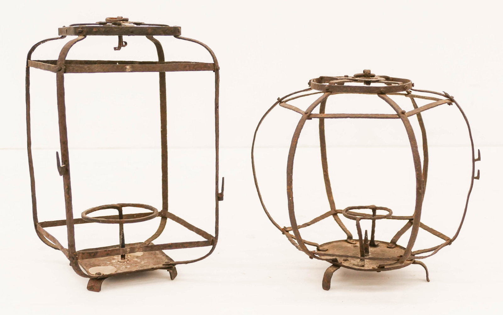2pc Japanese Edo Iron Lanterns 8'' to 10'' Tall: 2pc Japanese Edo Iron Pricket Lanterns 8'' to 10'' Tall. A duo of early candle hanging lanterns. Scattered surface wear from age. 18th or early 19th century. Collection of W. Gordon Menzies, Seattle.