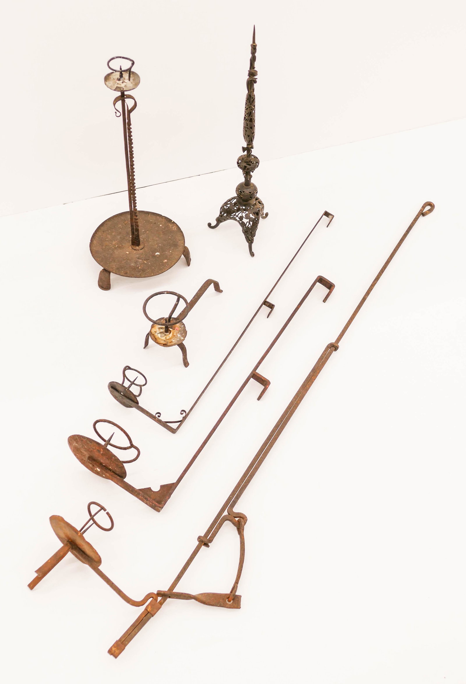 6pc Japanese Edo Iron Pricket Candleholders: 6pc Japanese Edo Iron Pricket Candleholders 9'' to 44'' Long. Includes a scrolled iron candlestick, an adjustable candlestick, a table candlestick, and three wall hanging candlesticks. Scattered wear 