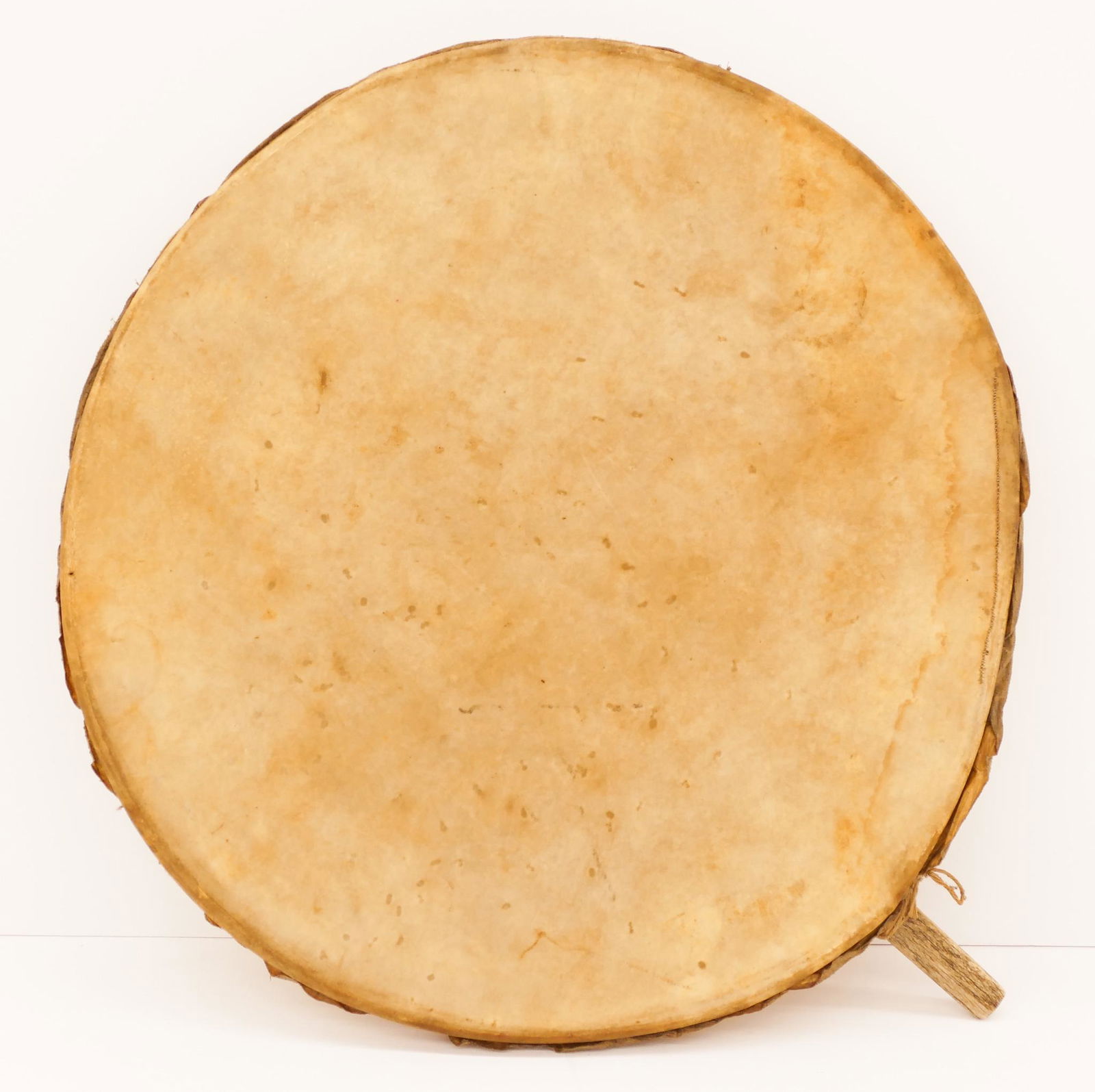 Old Inuit Eskimo Hoop Drum: Old Inuit Eskimo Hoop Drum 26''x22.5''. A bone handled native made drum. Some scattered wear from use. Circa 1940's or older.