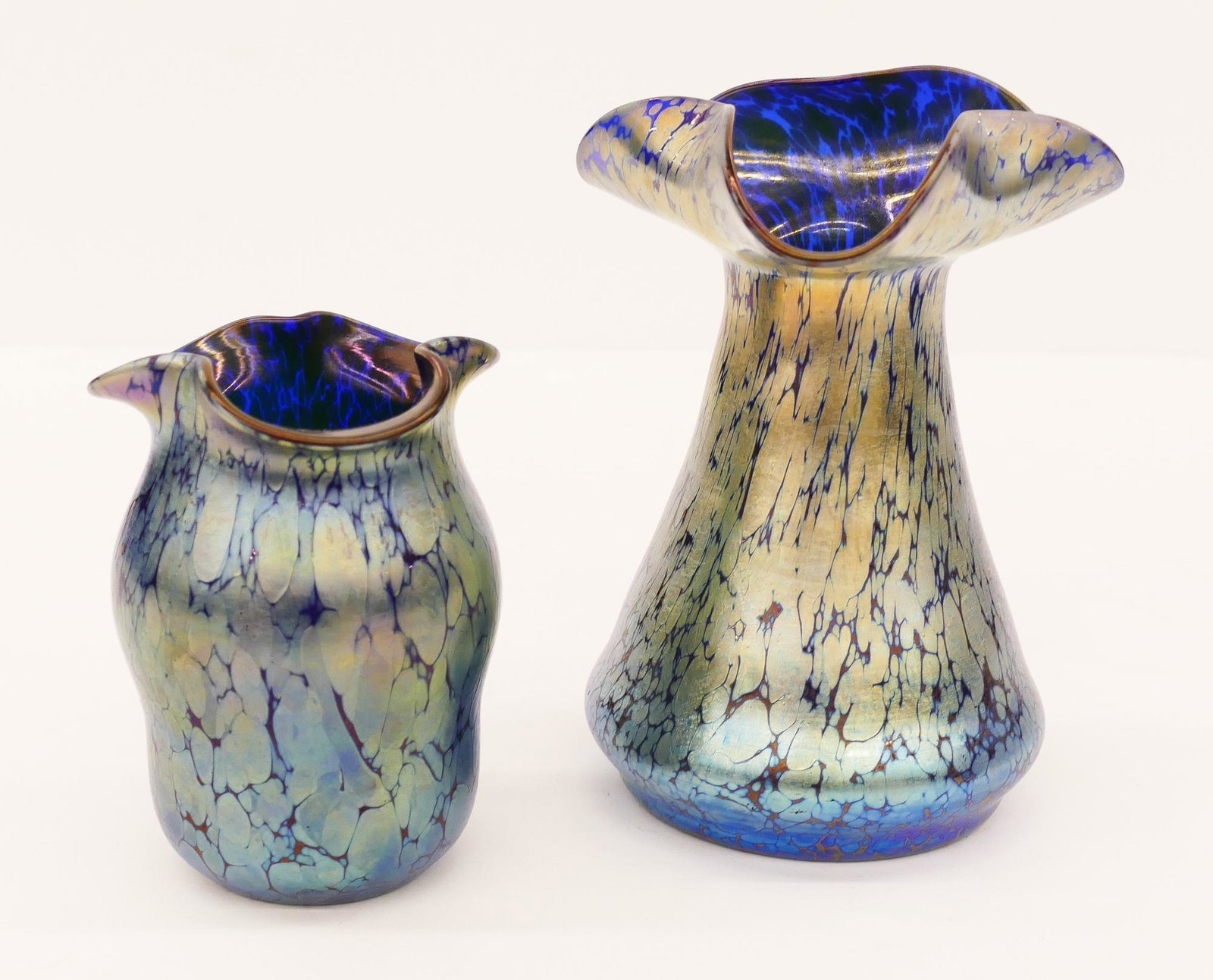 2pc Loetz Blue Oil Spot Glass Vases: 2pc Loetz Blue Oil Spot Glass Vases. Includes a tall trifoil rim vase 7.5''x5.5'' and a smaller gourd form ruffled edge vase 5.25''x3.75''. Unsigned. Excellent condition.